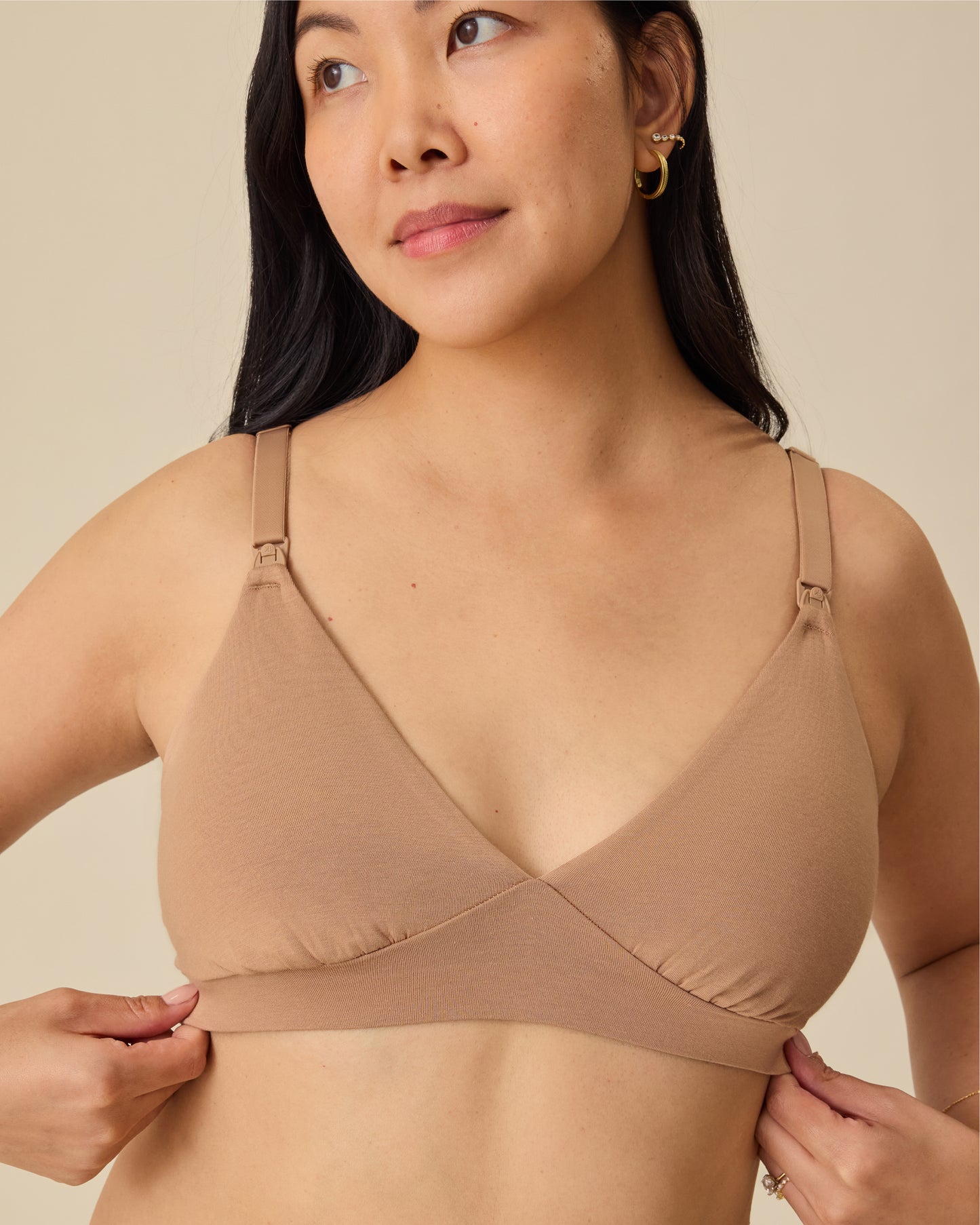 Model is wearing the SoftStretch Cotton Maternity & Nursing Bralette in Buff, on a beige background. 