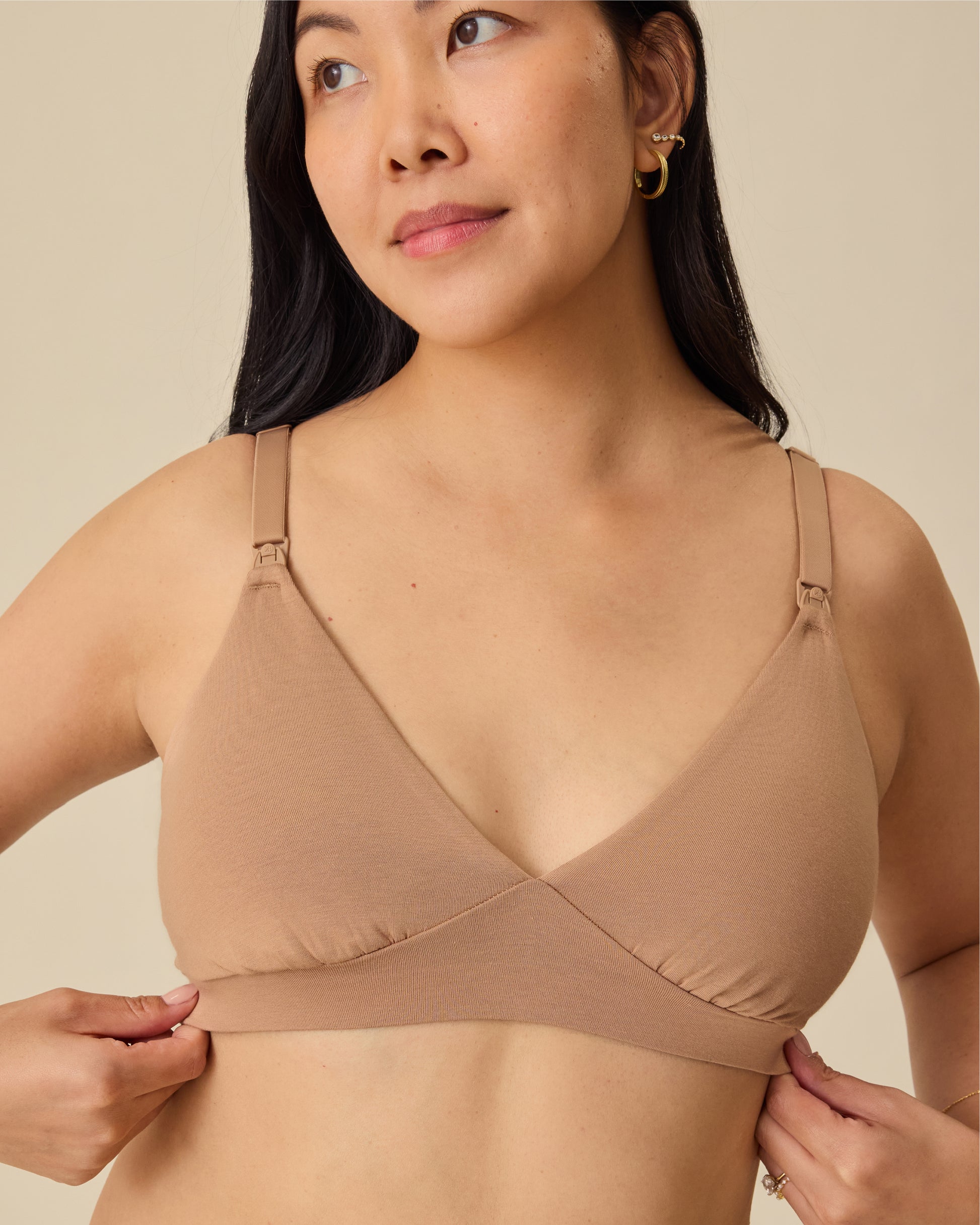 Model is wearing the SoftStretch Cotton Maternity & Nursing Bralette in Buff, on a beige background. 