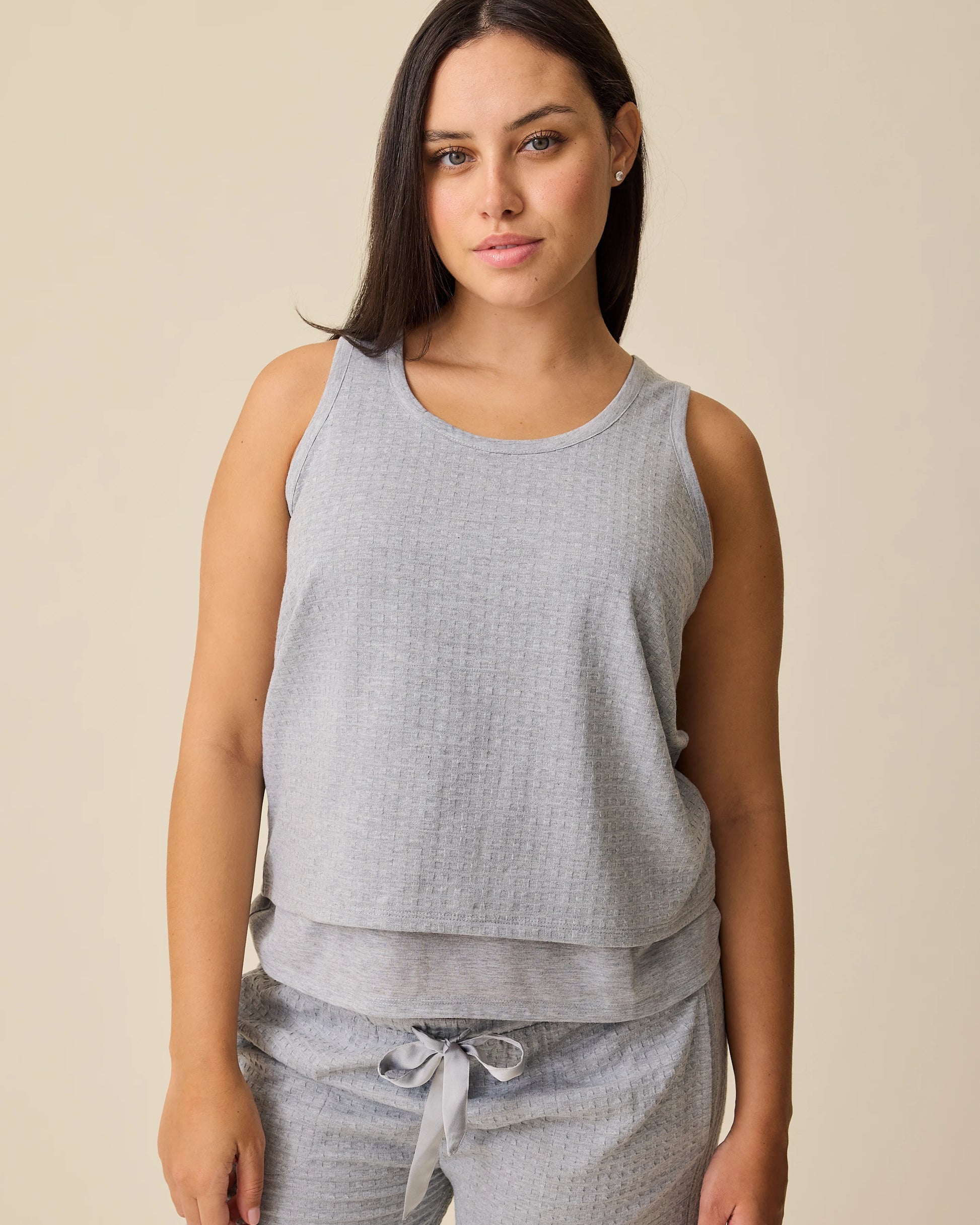 Model is wearing two of the three pieces of the Waffle Maternity & Nursing Three-Piece Lounge Set in Grey Heather on a beige background.