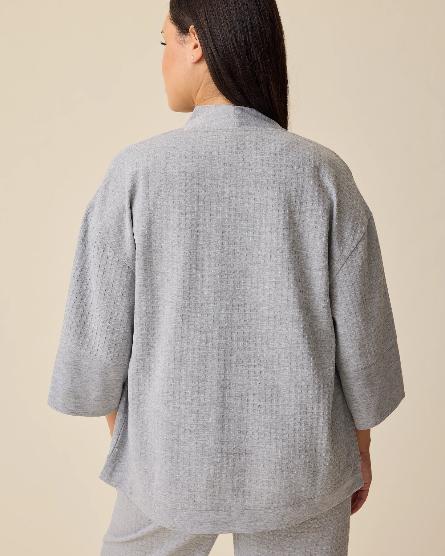 Back view of the Waffle Maternity & Nursing Three-Piece Lounge Set in Grey Heather on a beige background.