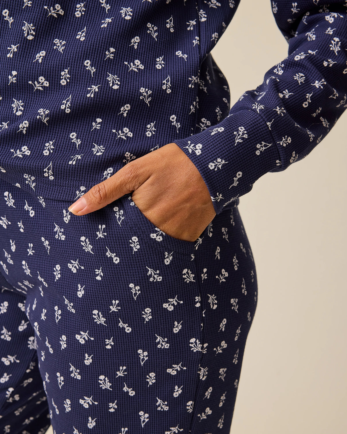 Close up of pocket on Waffle Maternity & Nursing Lounge Set in Navy Wildflower on a beige background.