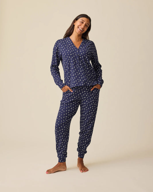 Model is wearing Waffle Maternity & Nursing Lounge Set in Navy Wildflower on a beige background.@model_info:Hayley is 5'7" and wearing a Small.