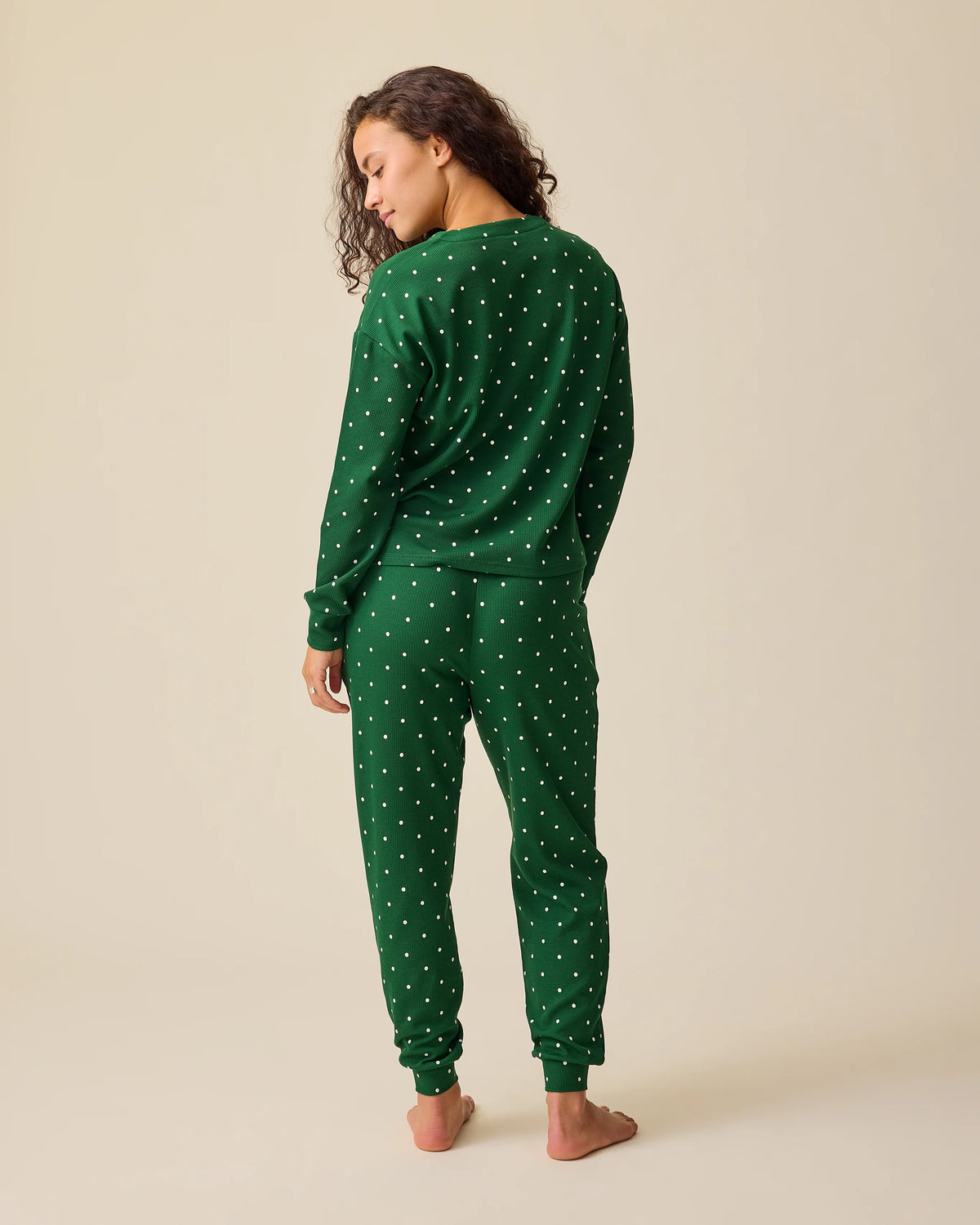 Back view on model wearing Waffle Maternity & Nursing Lounge Set in Green Dot on a beige background.