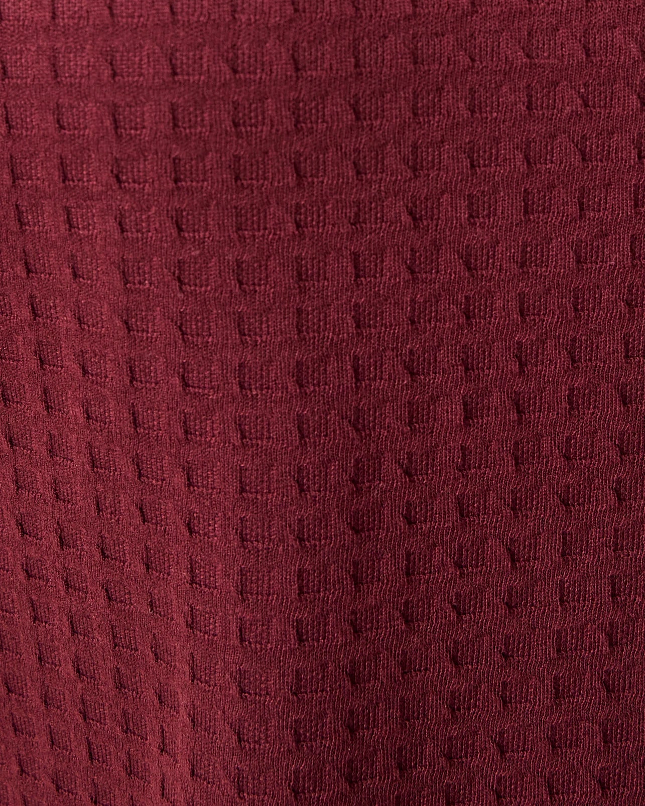 Close up of textured fabric of Waffle Maternity & Nursing Three-Piece Lounge Set in Garnet.