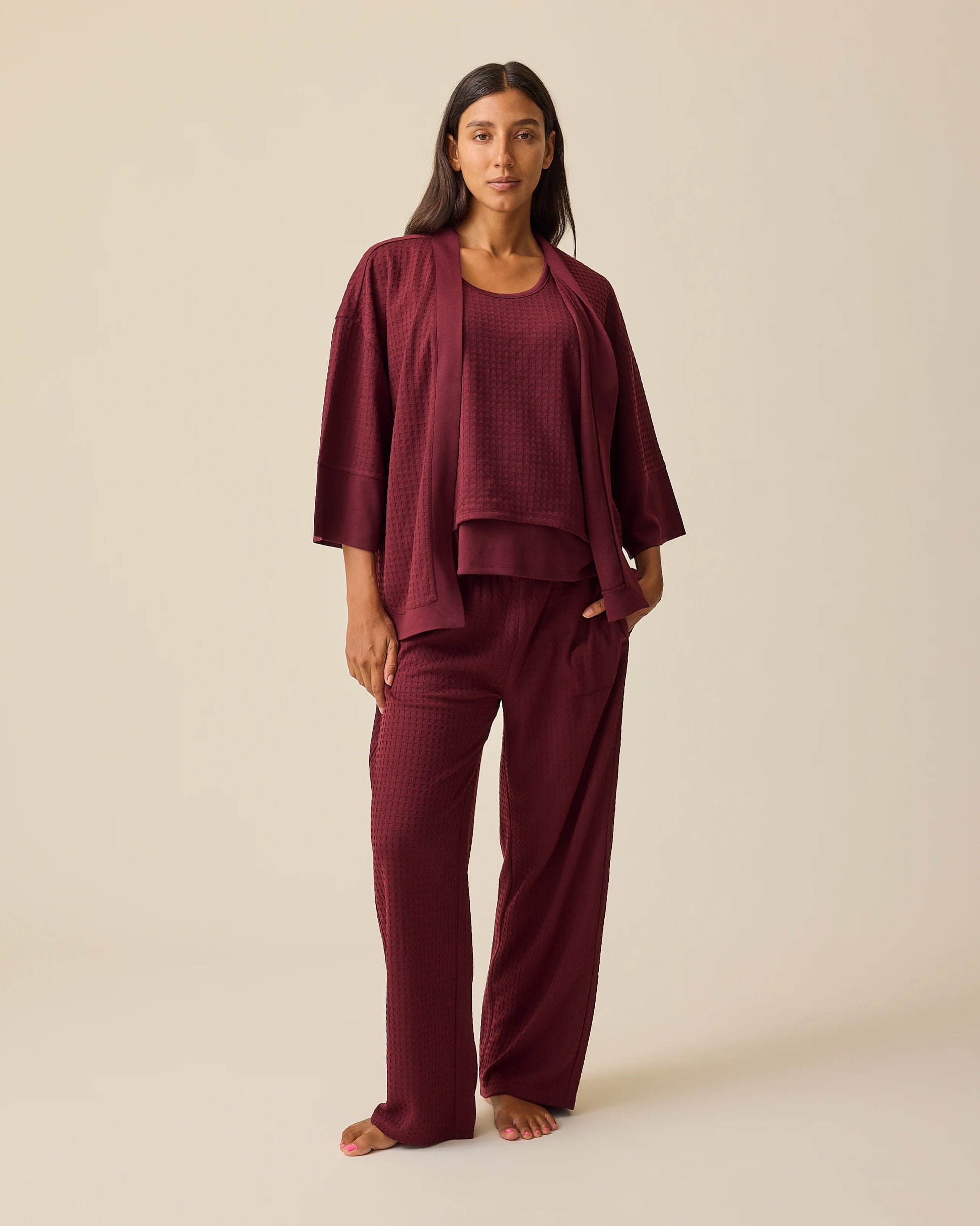 Model is wearing Waffle Maternity & Nursing Three-Piece Lounge Set in Garnet on a beige background. @model_info:Hayley is 5'7" and wearing a Small.