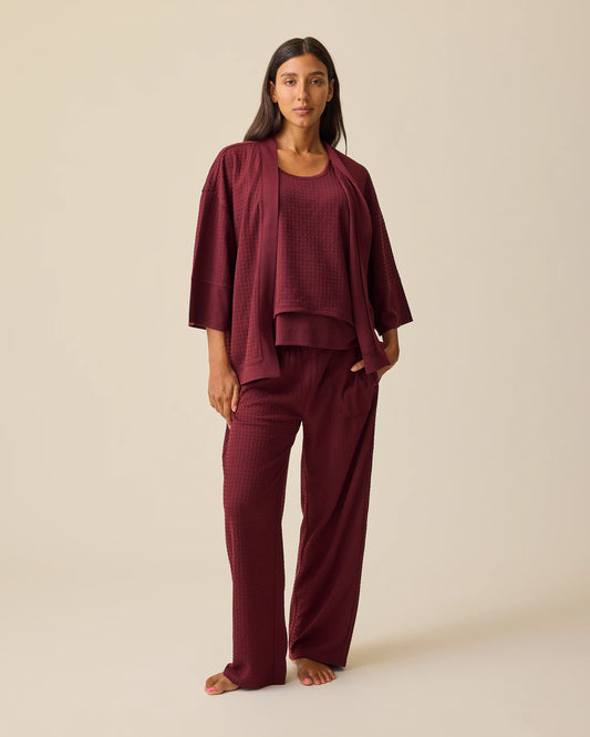 Model is wearing Waffle Maternity & Nursing Three-Piece Lounge Set in Garnet on a beige background. @model_info:Hayley is 5'7" and wearing a Small.