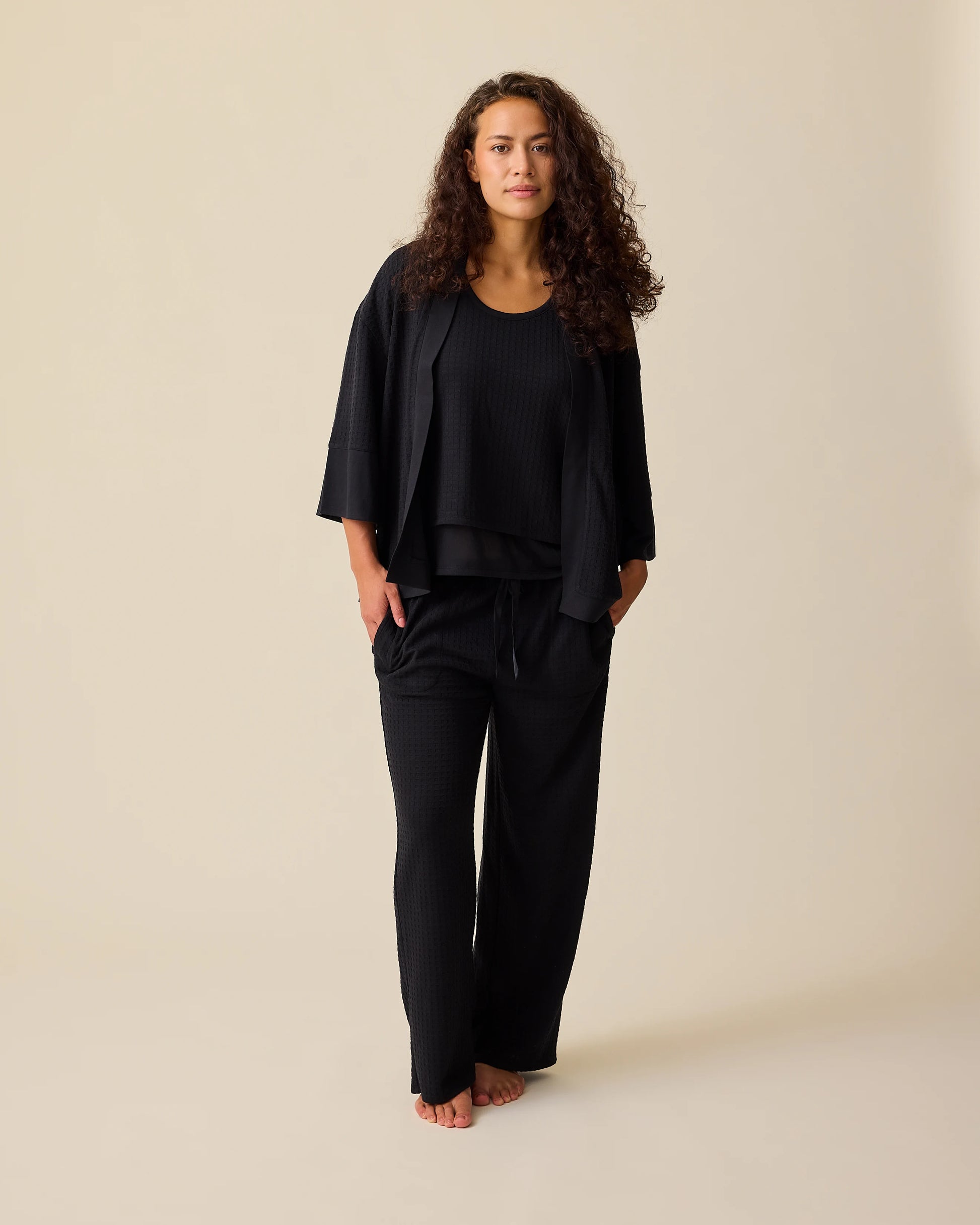 Model is wearing the Waffle Maternity & Nursing Three-Piece Lounge Set in Black on a beige background. @model_info:Sadie is 5'8" and wearing a Medium.