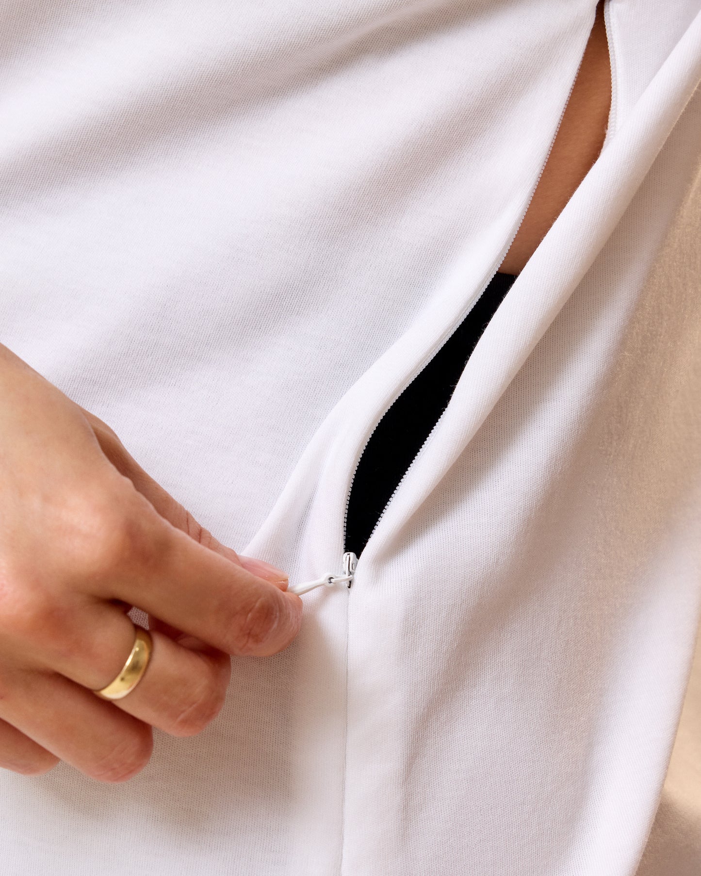Close up of model wearing Pima Cotton Side Zip Maternity & Nursing T-shirt in White showcasing the side zip