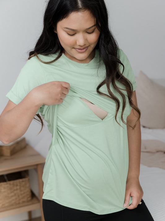 Model wearing the Everyday Asymmetrical Nursing T-shirt in Soft Mint showing the nursing access. @model_info:Binc is wearing a Medium.