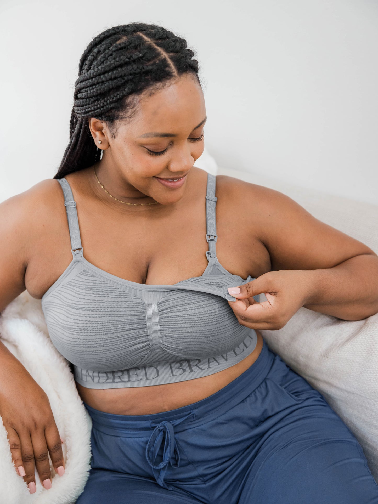 Model wearing the Sublime® Hands-Free Pumping & Nursing Bra in grey showing the convenient clip down nursing access feature@model_info:Roxanne is wearing a Large.
