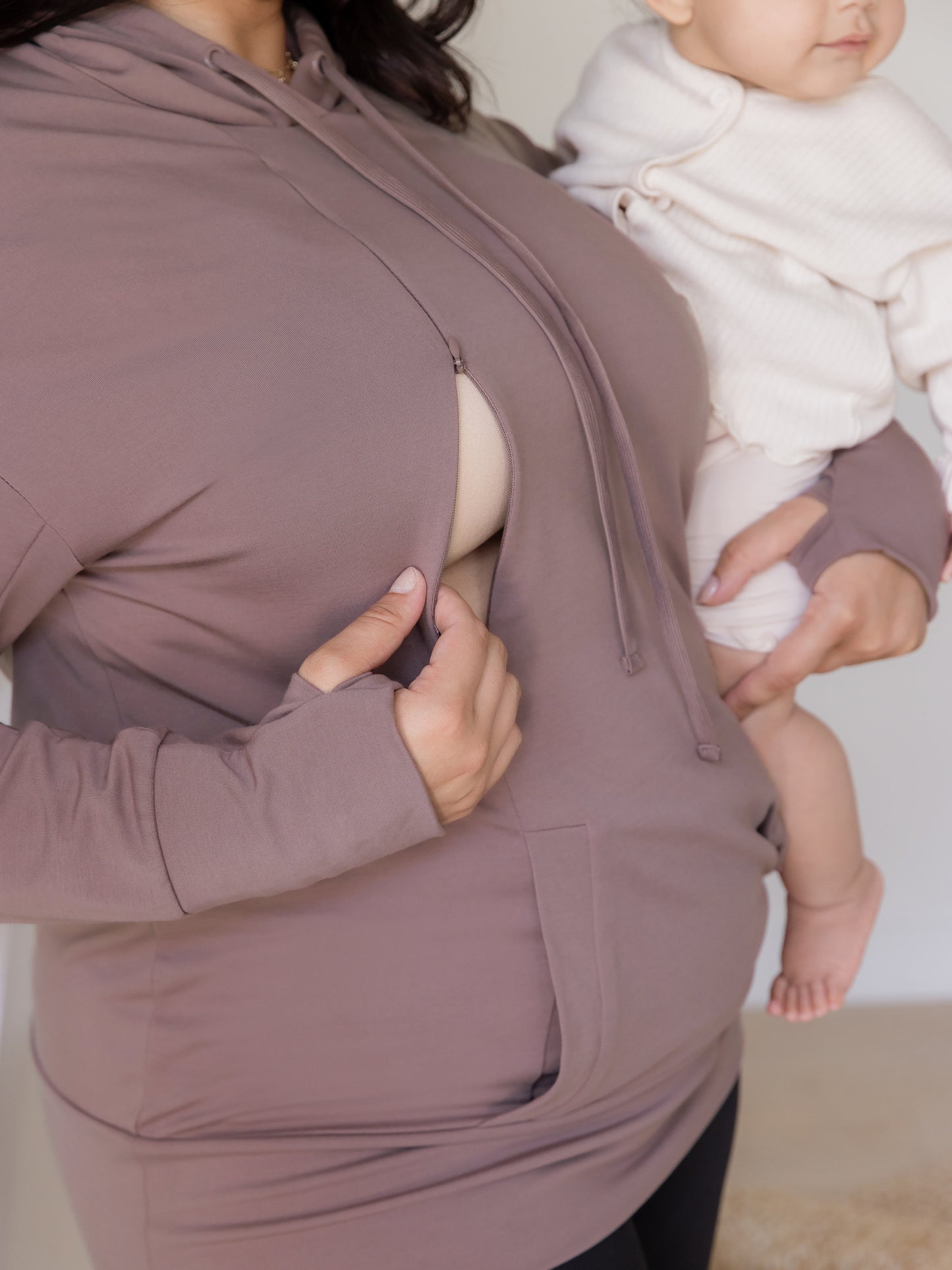 Close up view of nursing access on the Bamboo Maternity & Nursing Hoodie in Twilight, with model holding baby