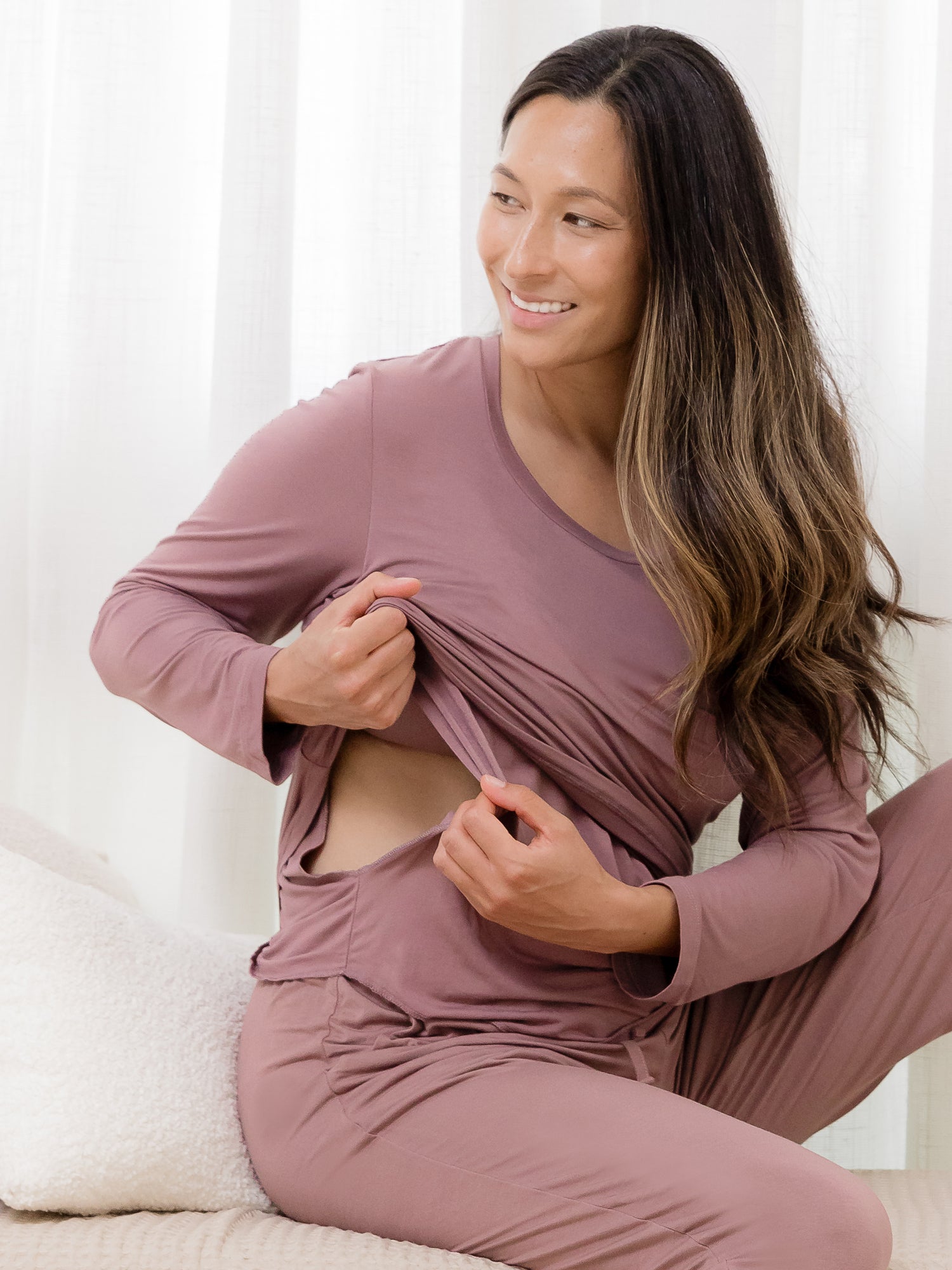 Model sitting and wearing the Bamboo Maternity & Nursing Long Sleeve T-shirt in Twilight, showing nursing access