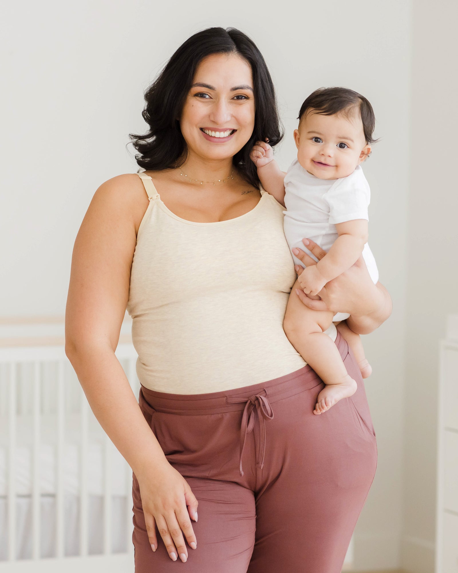 Model holding baby and wearing the Sublime® Bamboo Hands-Free Pumping & Nursing Camisole in Oatmeal Heather@model_info:Connie is wearing an X-Large Busty.
