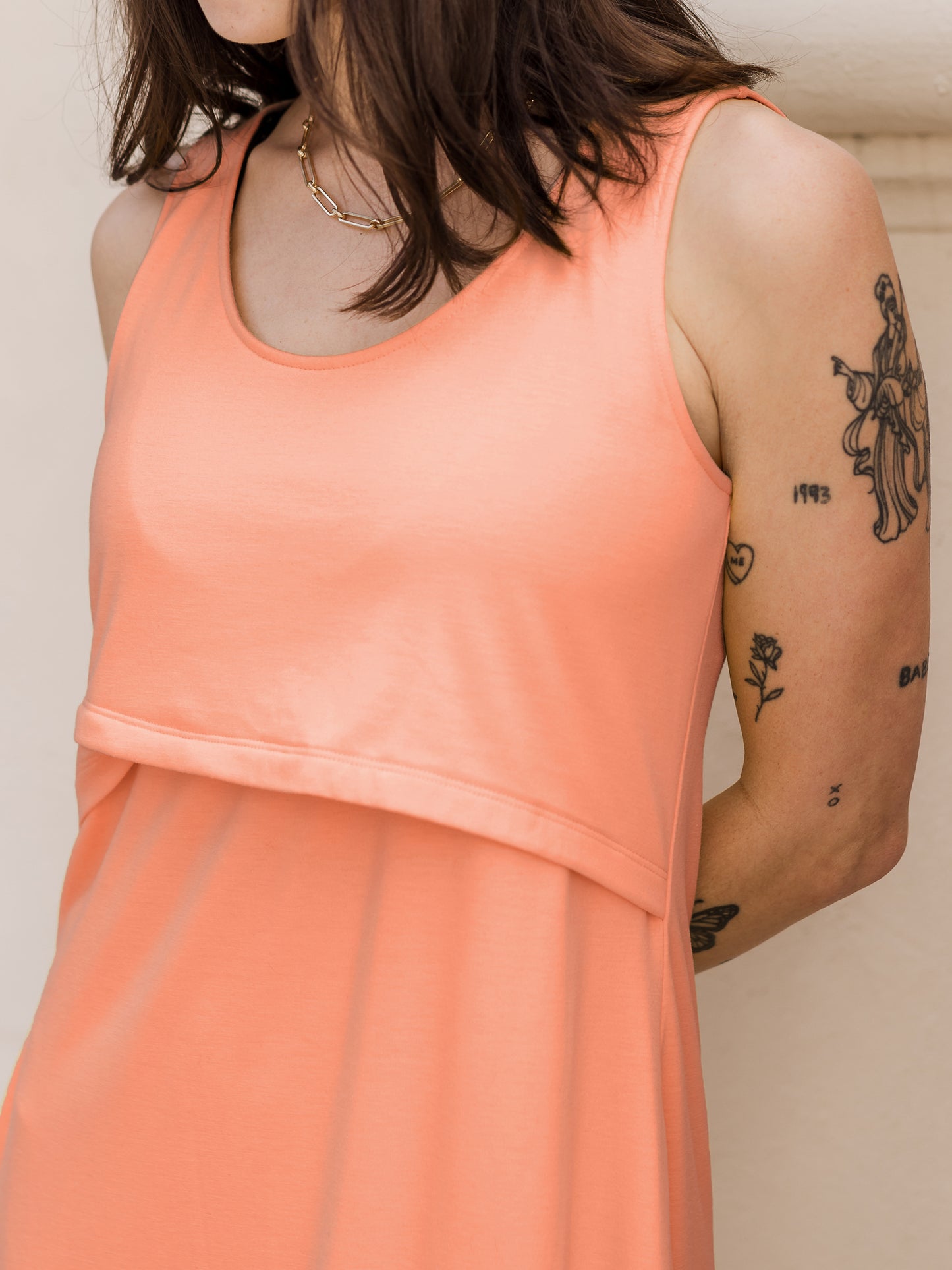 Close-up detail shot Penelope Crossover Nursing Dress in vintage coral on model 