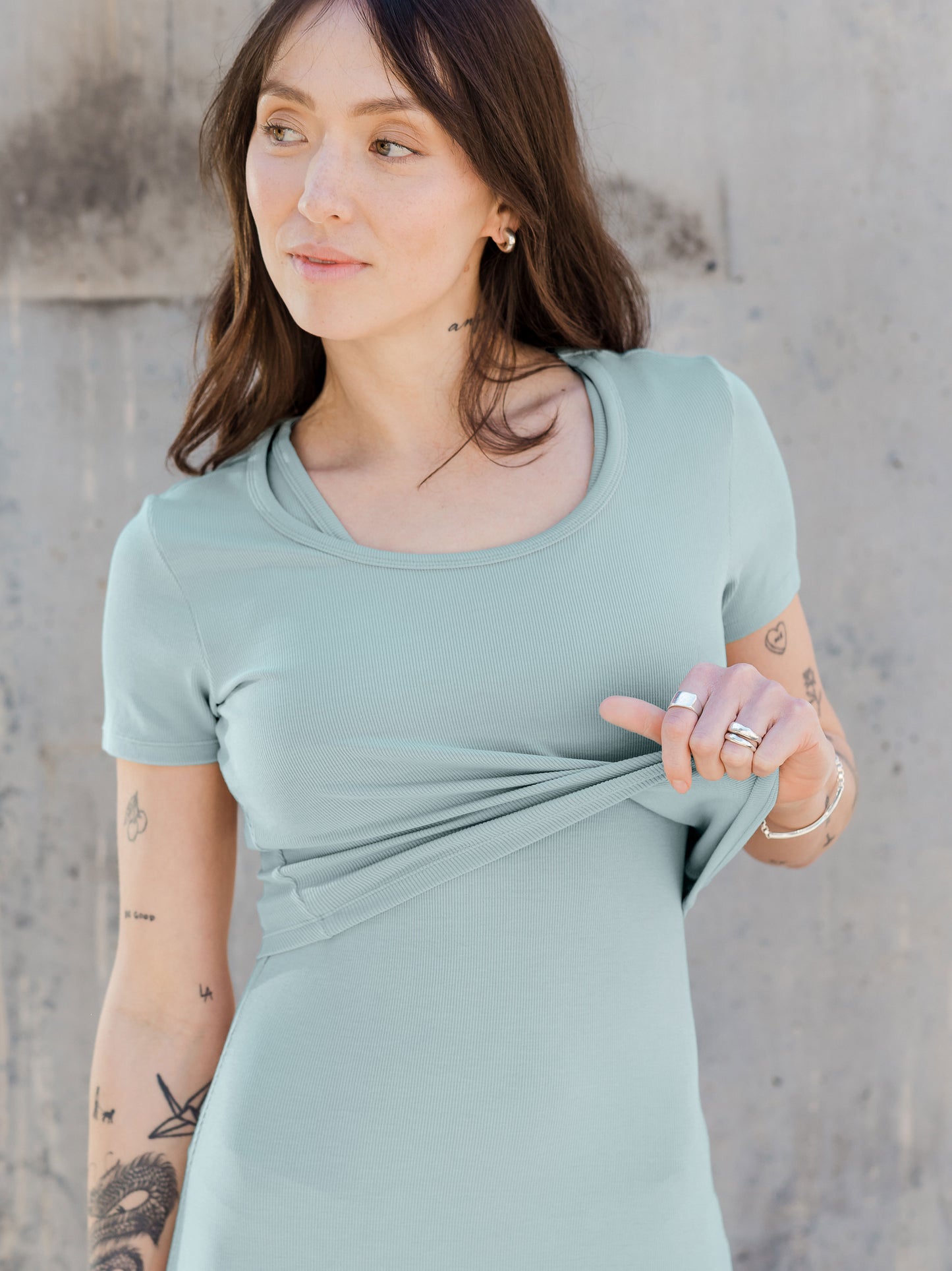 Model wearing the Olivia Ribbed Bamboo 2-in-1 Maternity & Nursing Dress in Dusty Blue Green, showing the removable crop top feature.