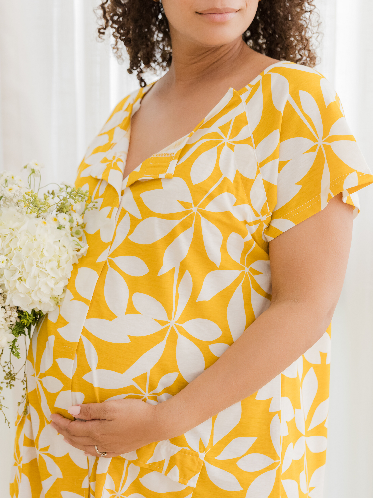 Close-up of the detail on the Universal Labor & Delivery Gown in Honey Leaf, on model