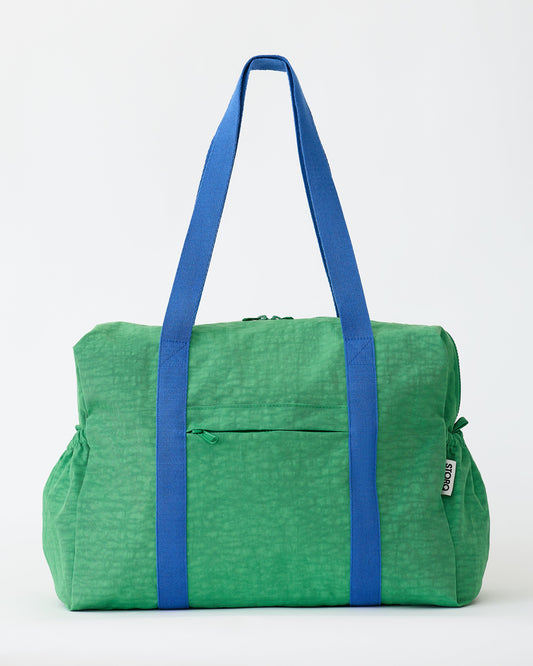 The Large Weekender Bag in Green on an off white background.