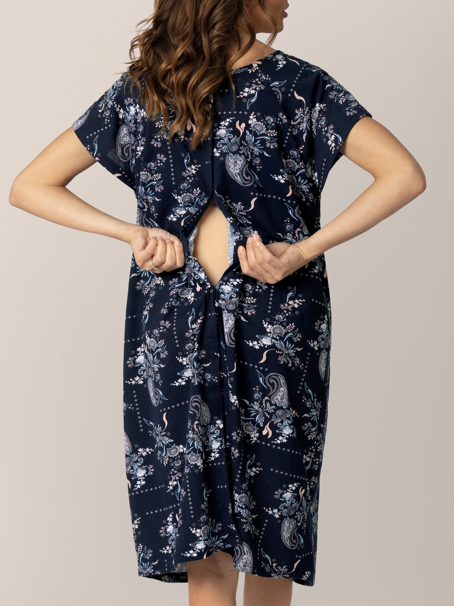 Back view of model wearing the Universal Labor & Delivery Gown in Navy Paisley, showing opening.