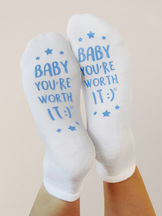Socks reading Baby you're worth it :) in blue raised ink.