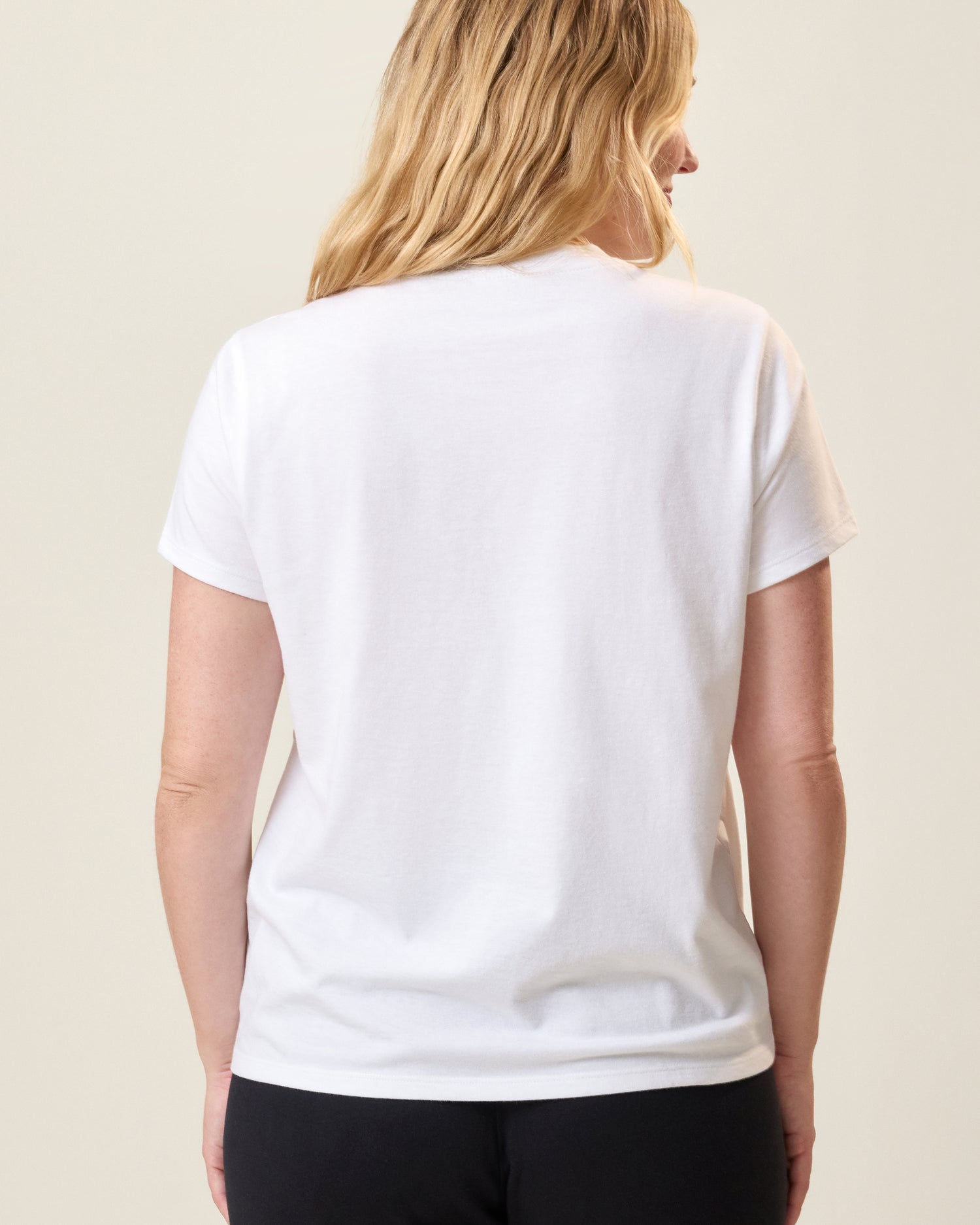 Back view of model wearing Classic Cotton Nursing T-shirt in White on a neutral background