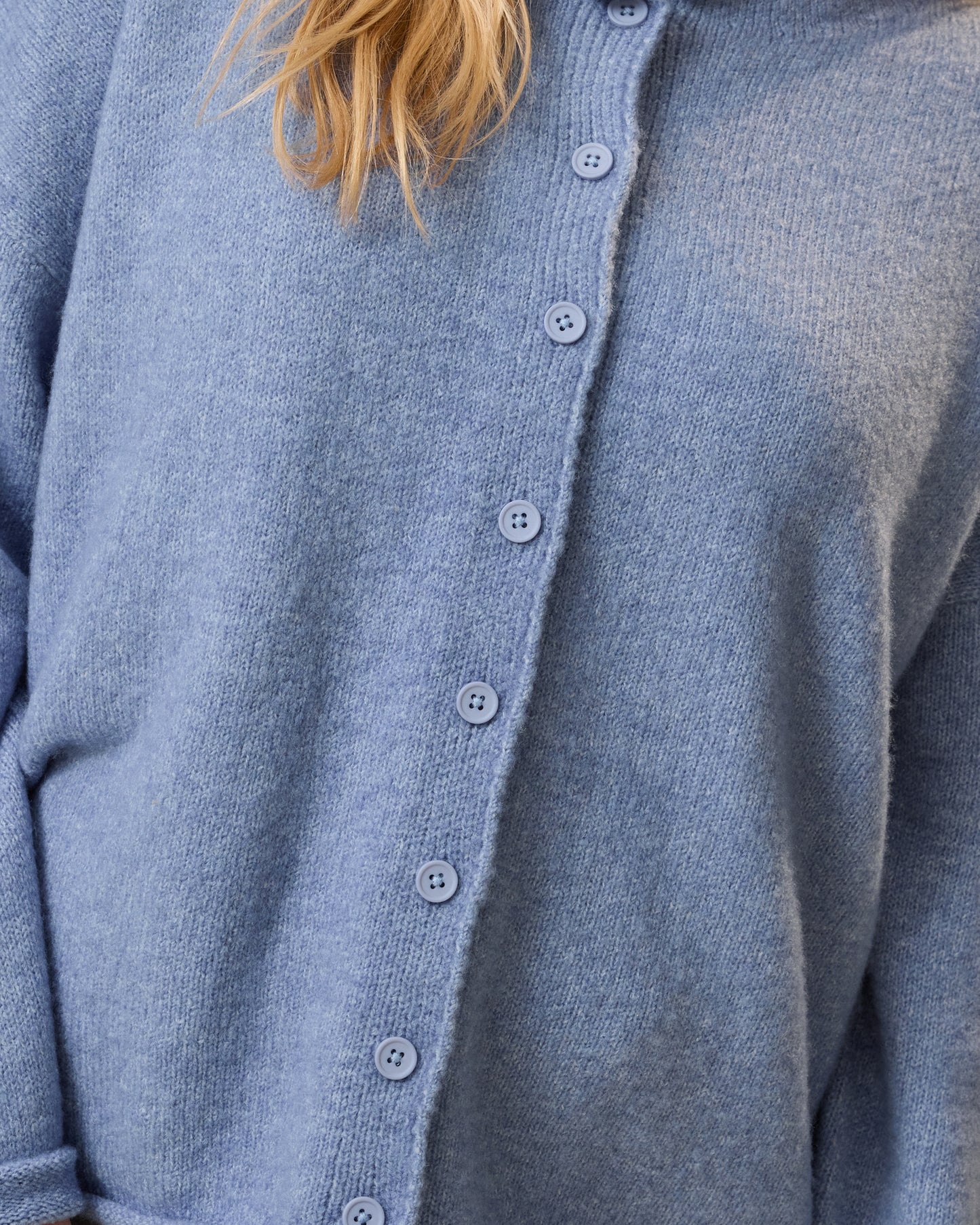 Close-up of a blue cardigan with buttons