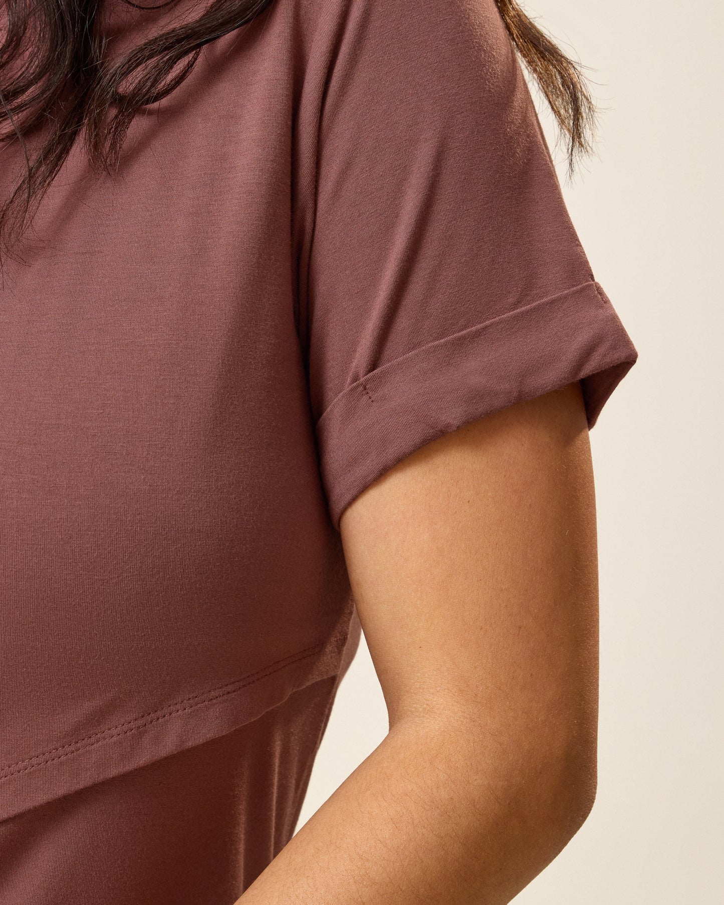 Close up of model wearing the Asymmetrical Nursing T-shirt in Redwood showing a detail of the sleeve