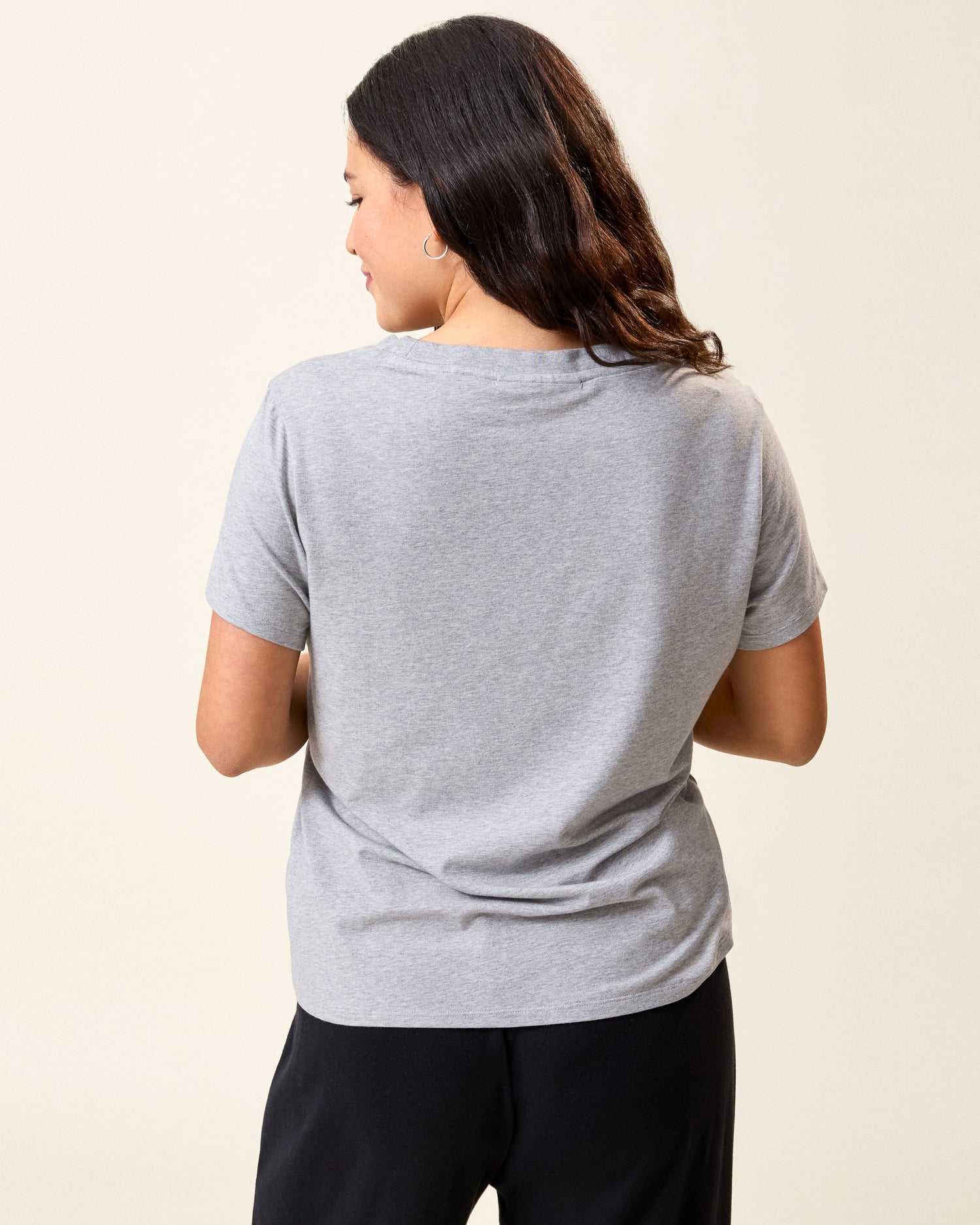 Back view of model wearing Classic Modal V-neck Nursing T-shirt in Grey Heather on a neutral background