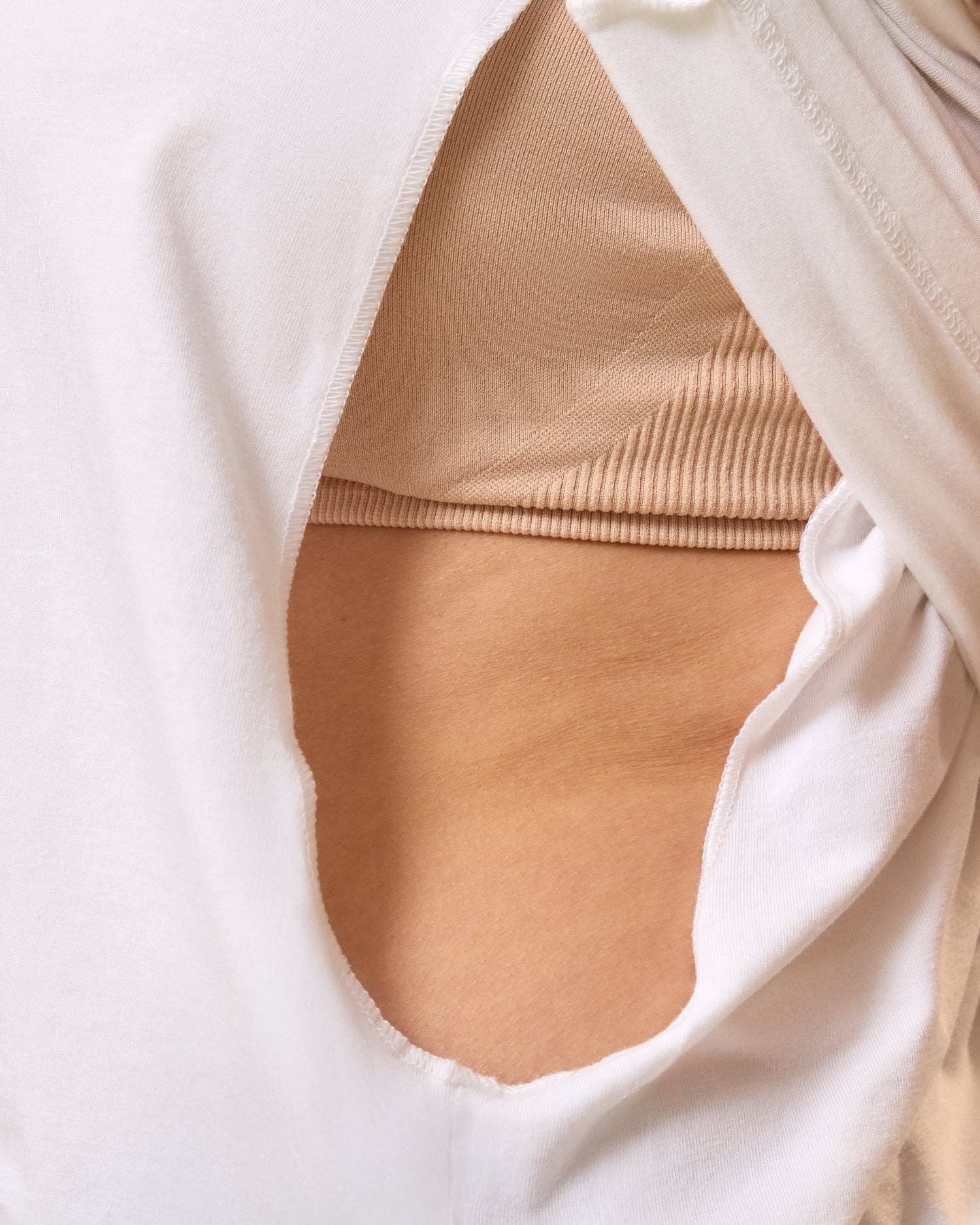 Close up of model wearing Slim Fit Modal Nursing T-shirt in White showing the hidden side access for breastfeeding