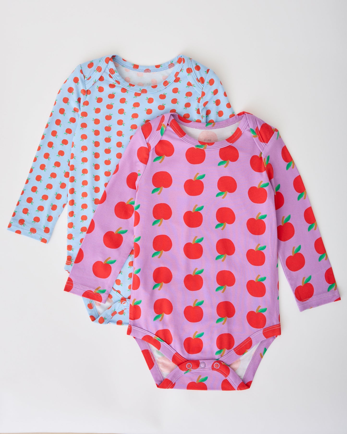 Long Sleeve Bamboo Onesie Two-Pack in Apple pattern on a gray background.