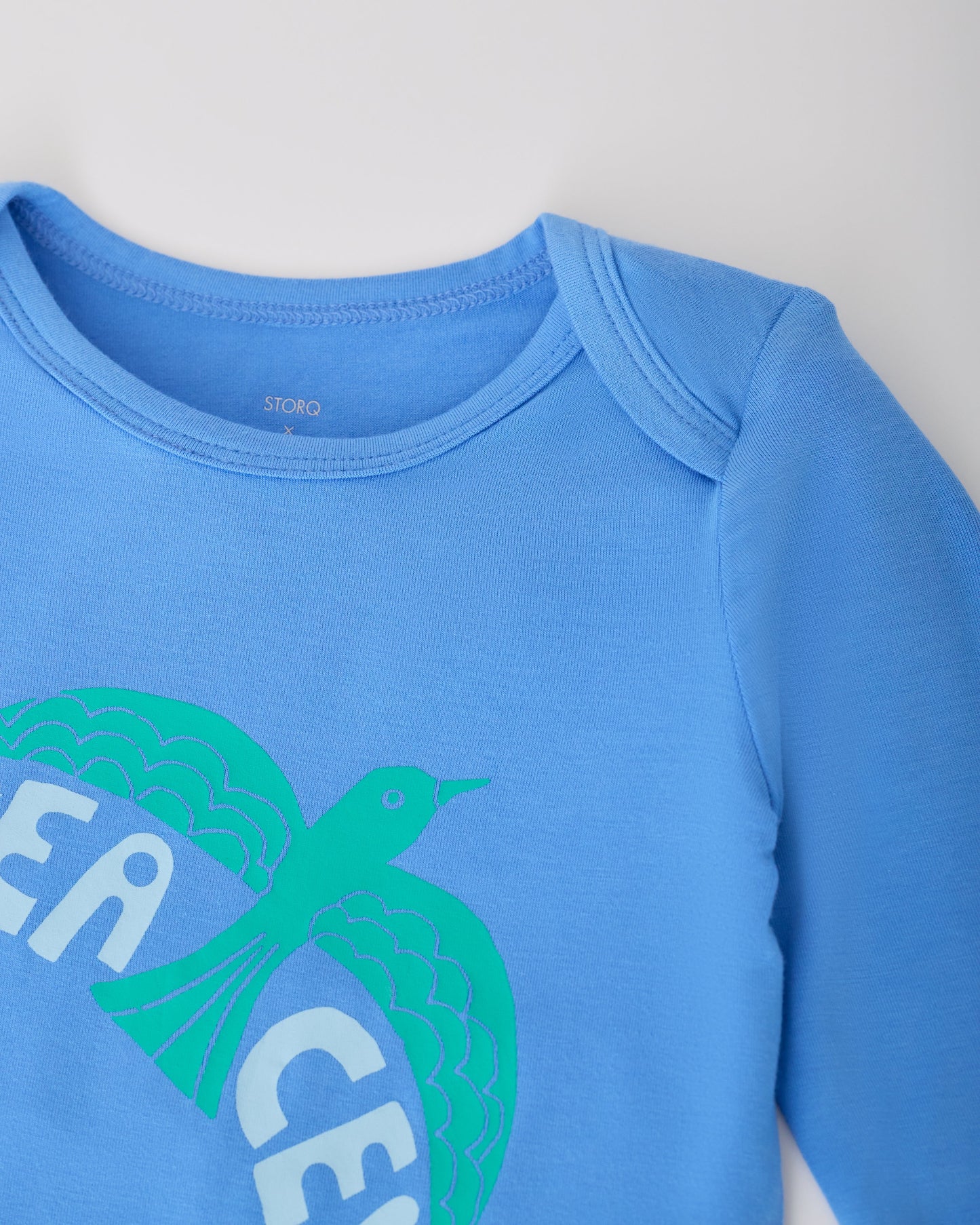 Close up of collar on Blue Bird in the Long Sleeve Bamboo Onesie Two-Pack in Bird on a white background.