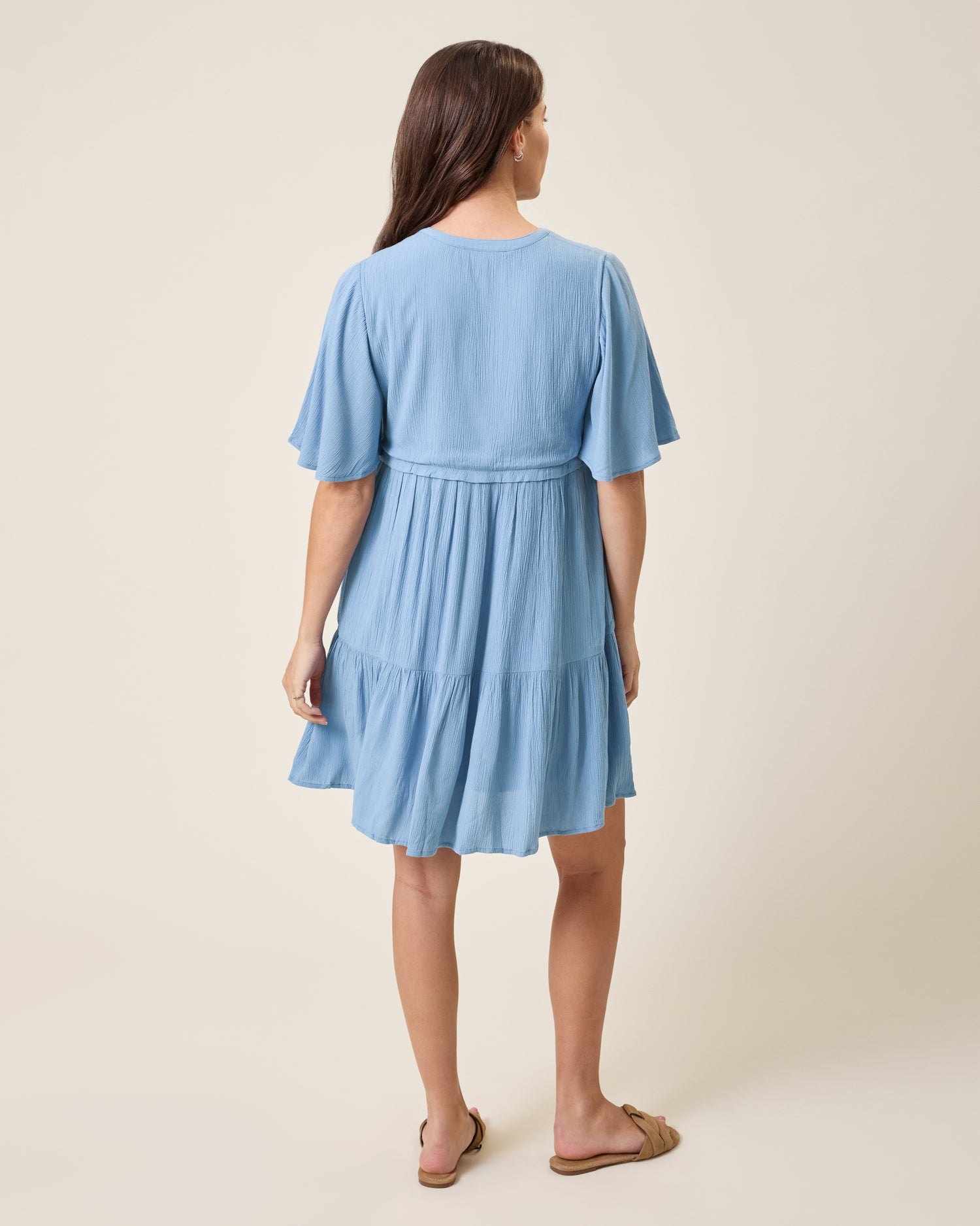 Back view of model wearing Marlowe Maternity & Nursing Mini Dress in Vintage Blue