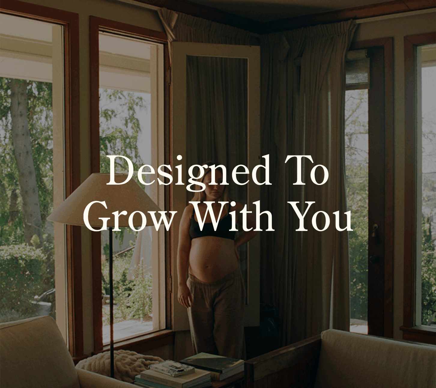 White text: Designed to Grow with You. Rotating gif of images of mother and child in living room. Kate is wearing cotton Bamboo Robe in Taupe and Cotton Bamboo Pajama pants in Taupe. Child is wearing Bamboo Baby Pajama in Blue Watercolor.