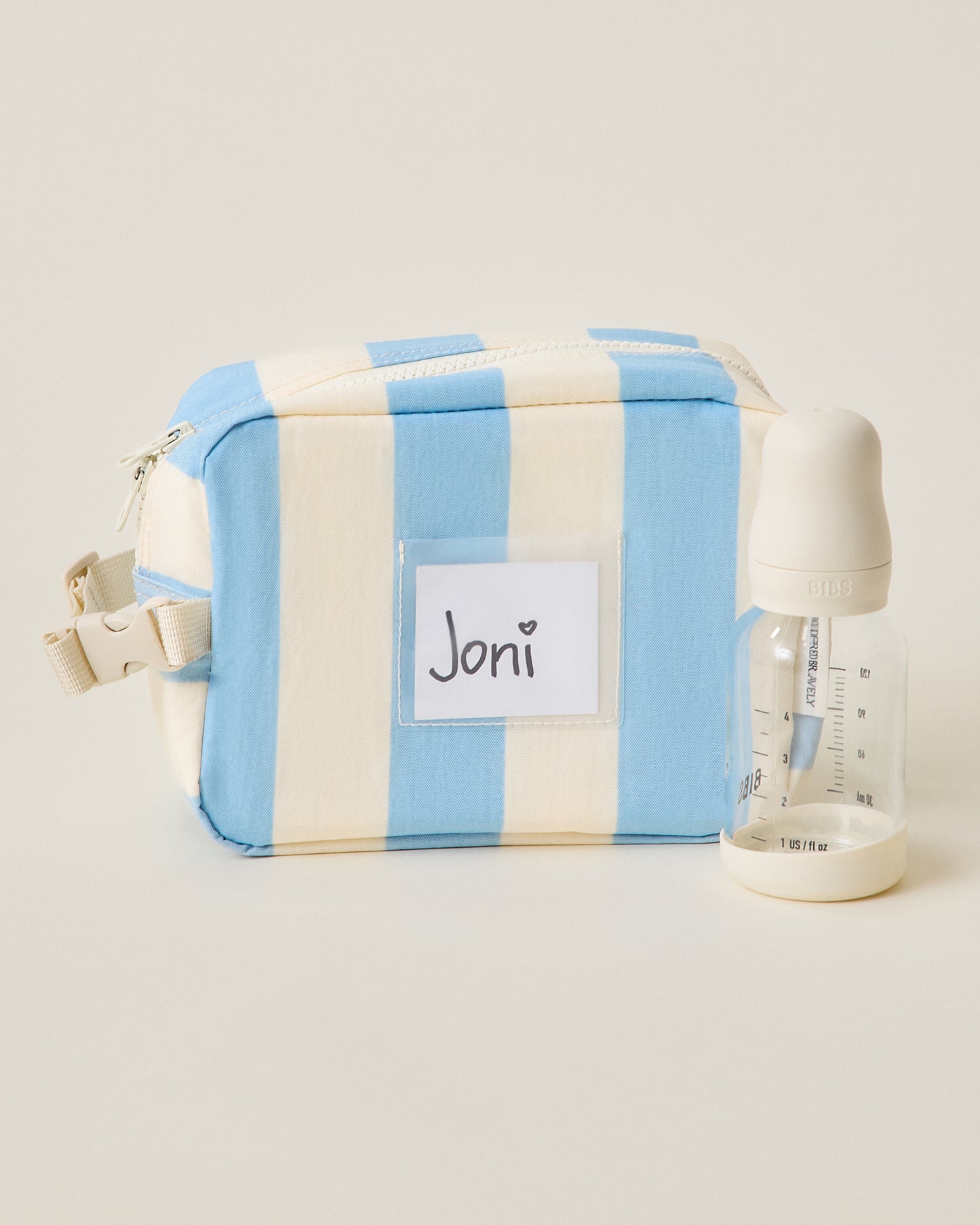 Mini Cooler Bag in Blue Wide Stripe pattern with bottle next to it