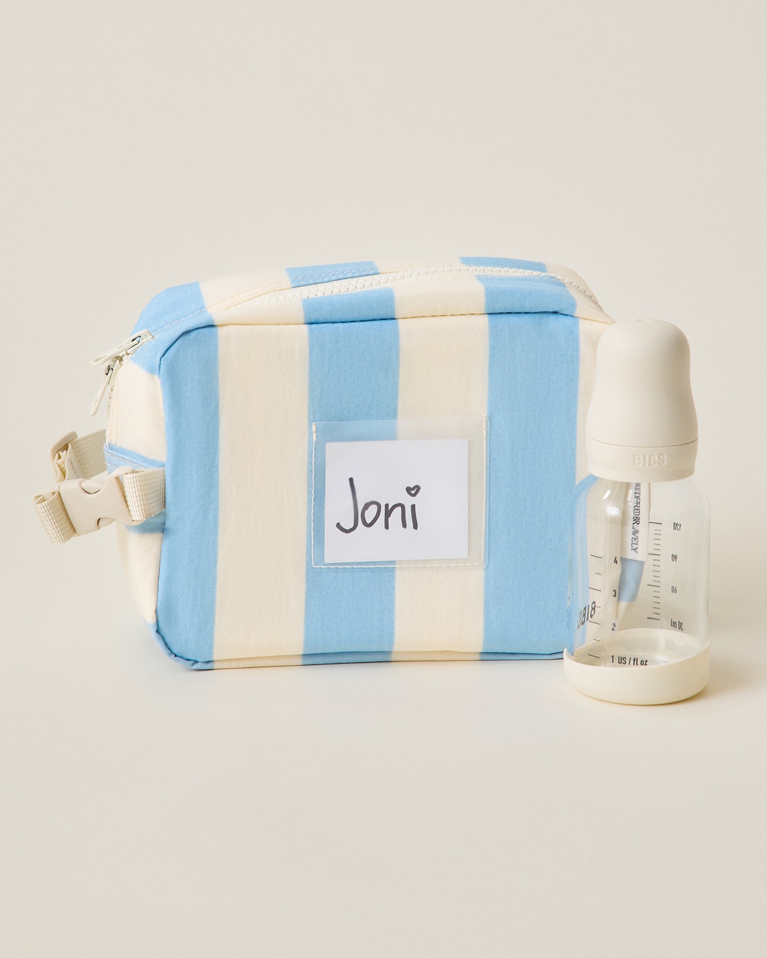Mini Cooler Bag in Blue Wide Stripe pattern with bottle next to it
