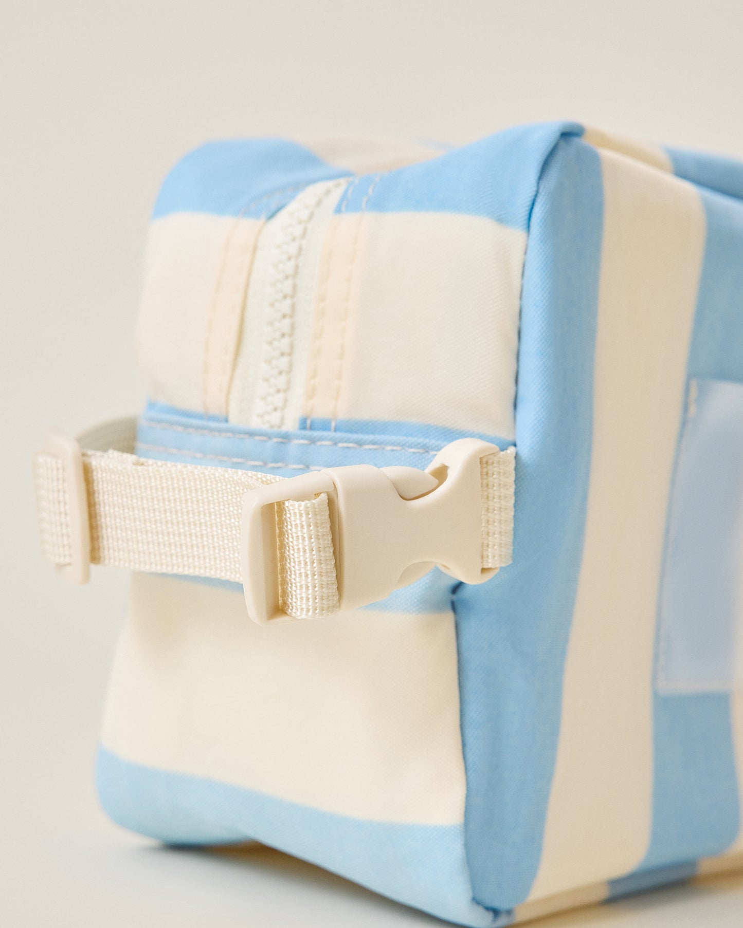 Close-up of strap and buckle on the Mini Cooler Bag in Blue Wide Stripe pattern