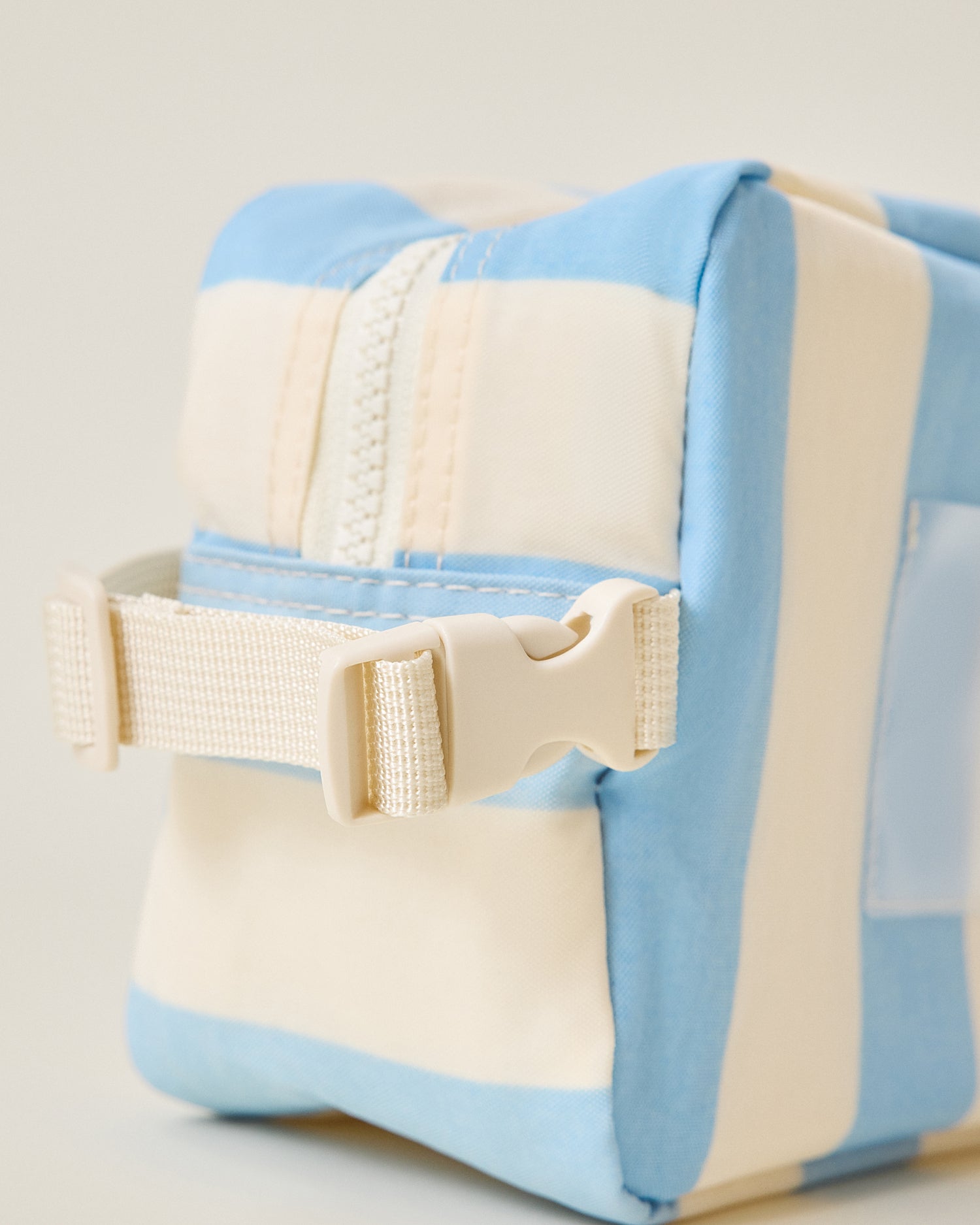 Close-up of strap and buckle on the Mini Cooler Bag in Blue Wide Stripe pattern