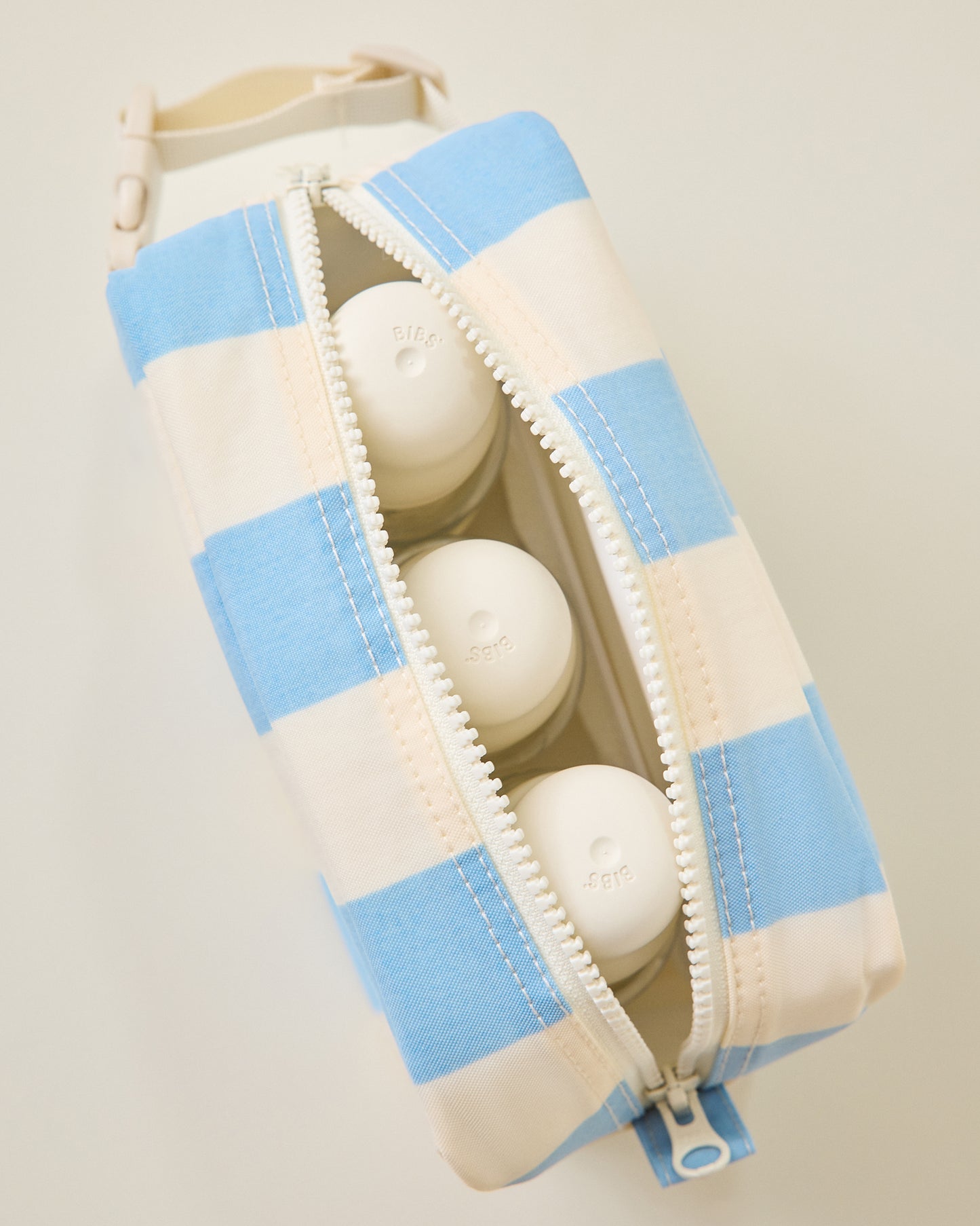 Mini Cooler Bag in Blue Wide Stripe pattern with zipper open showing three bottles inside