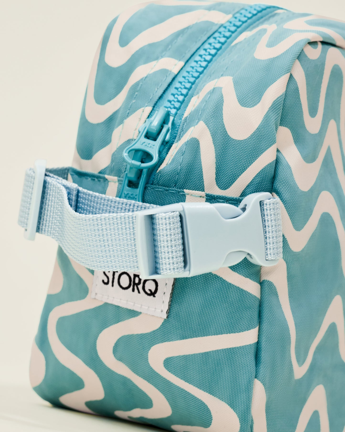 Close up of the Mini Cooler Bag in the Blue Waves print, showing a detail of a handle with a clasp