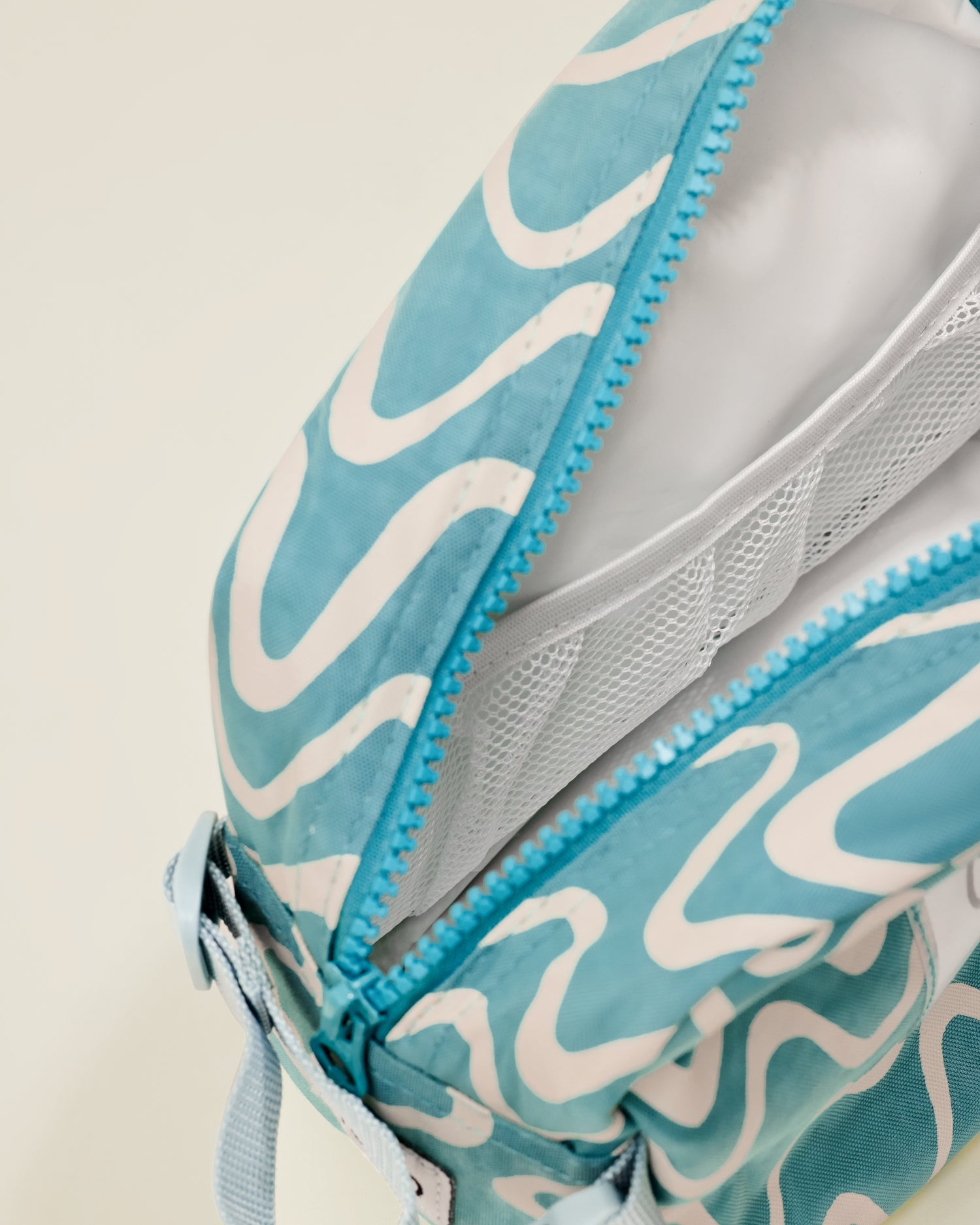 Close up of the Mini Cooler Bag in the Blue Waves print, showing a mesh compartment inside the bag