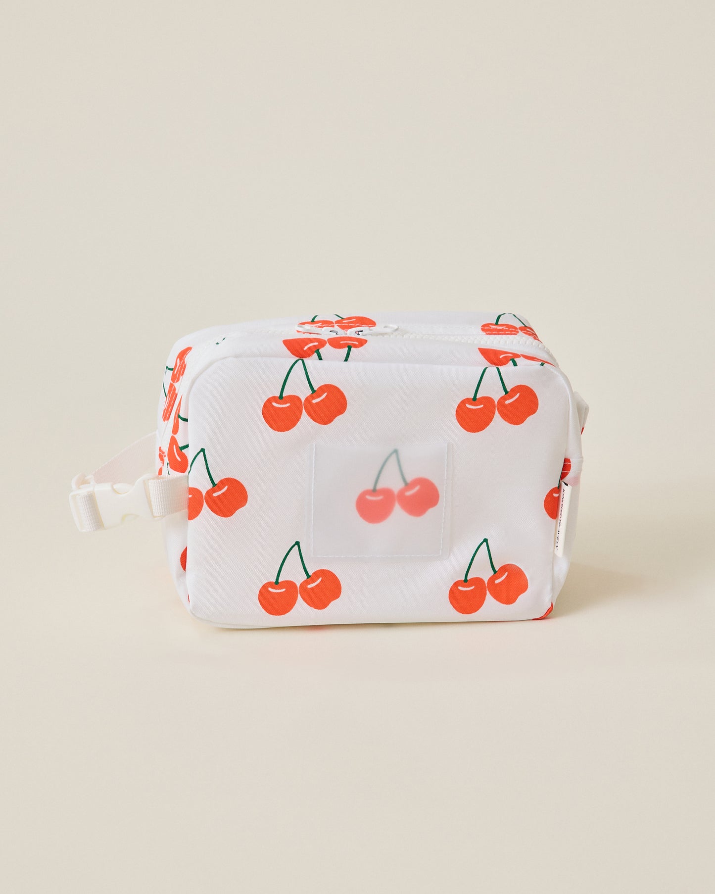 White Mini Cooler Bag with red cherry pattern on a beige background
