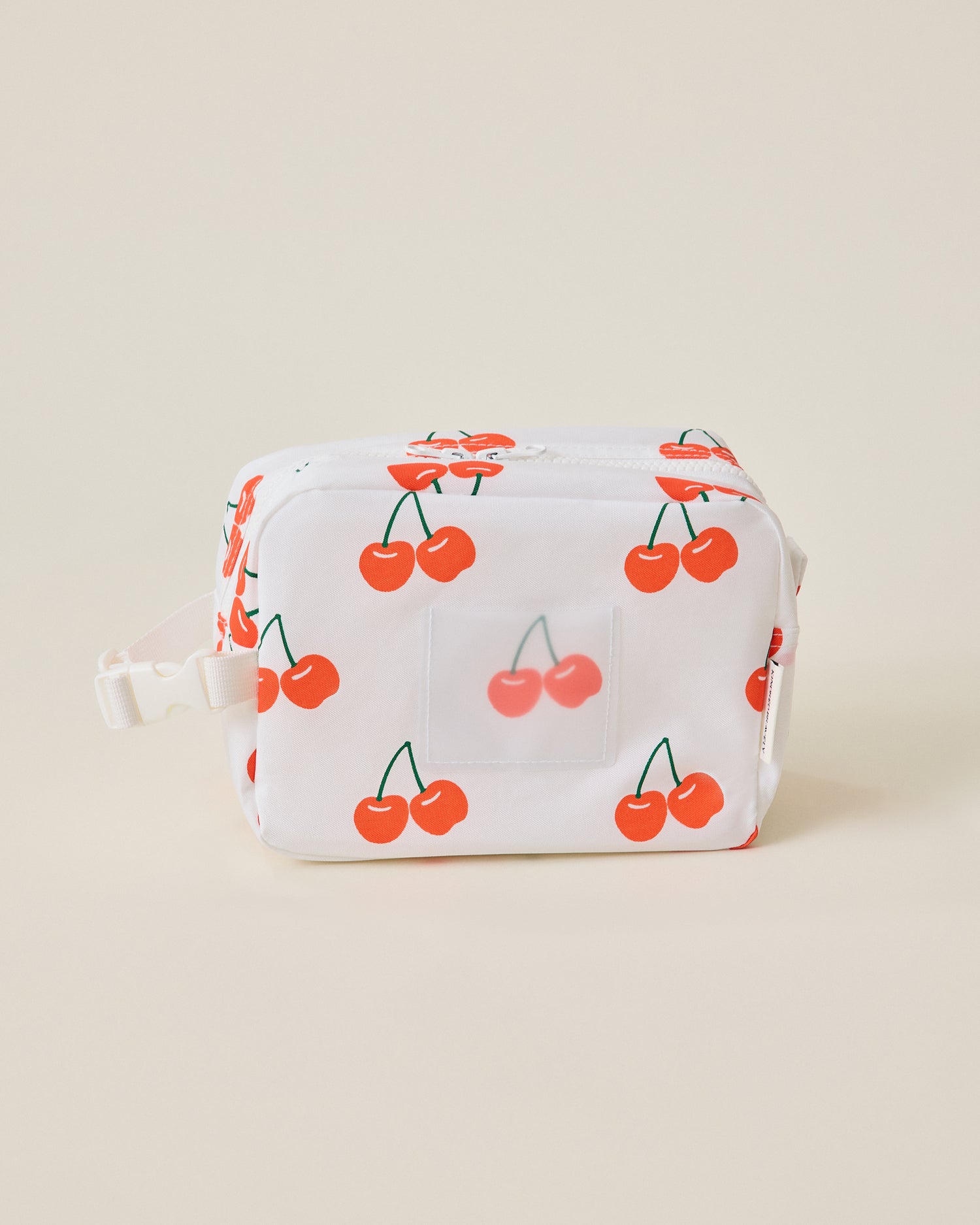 White Mini Cooler Bag with red cherry pattern on a beige background