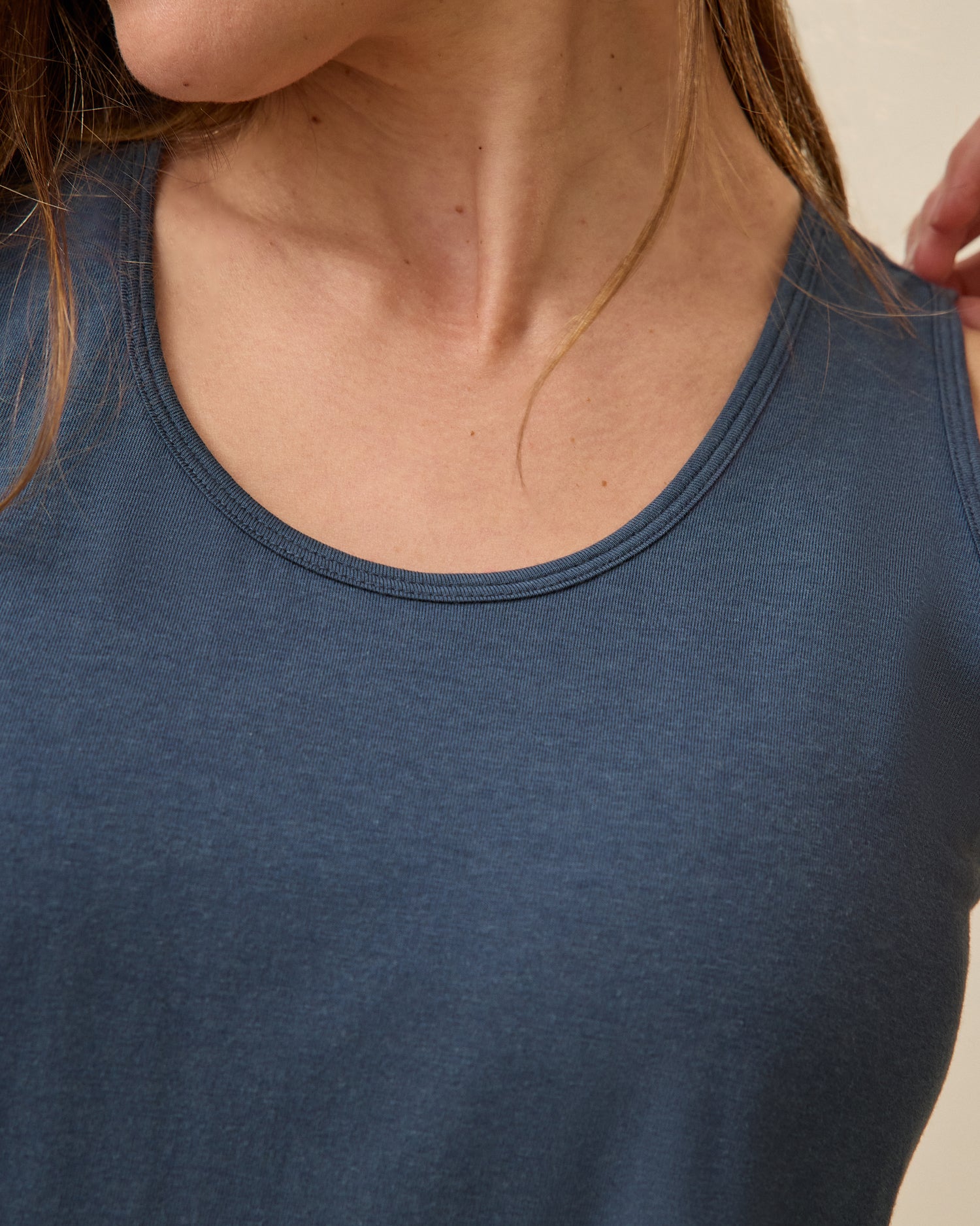 Close up of Model wearing Modal Signature Nursing Tank in Midnight Blue on a beige background.