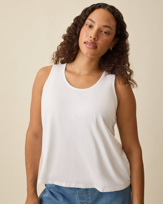 Model is wearing Modal Signature Nursing Tank in White on a beige background. @model_info:Mei is wearing a Small.