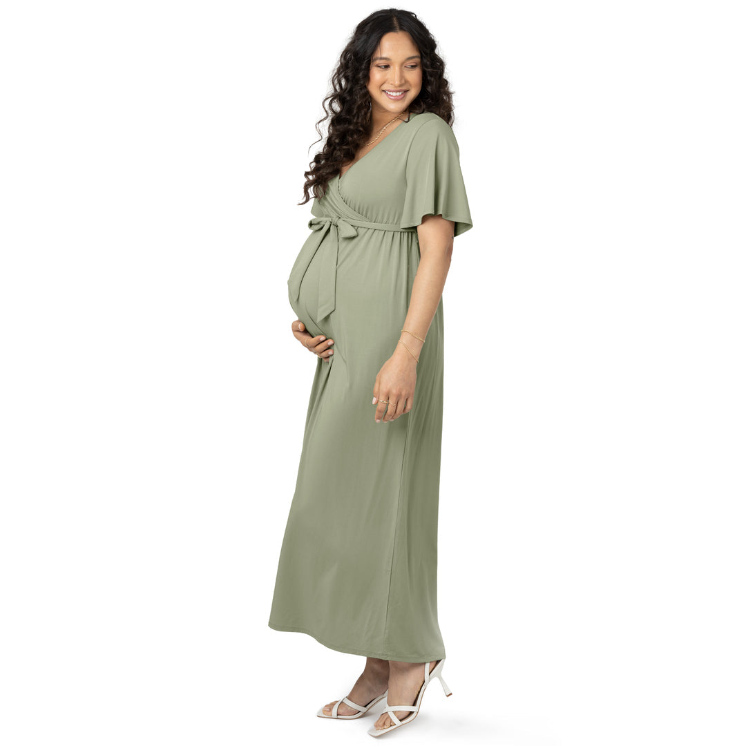 Model wearing the Wrap Maternity Maxi Dress in Rosemary with her hand on her baby bump 