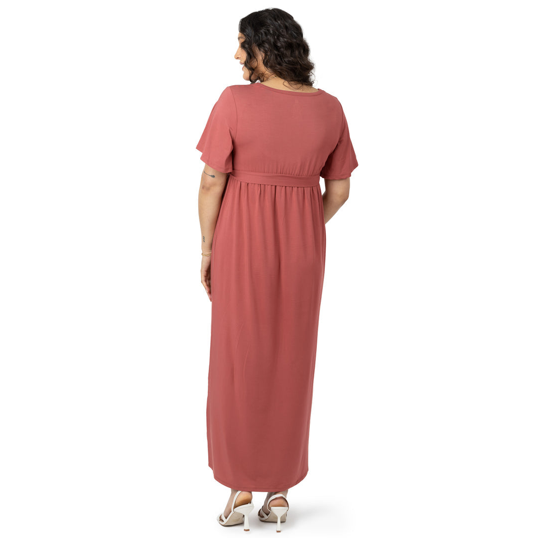 Back view of a pregnant model wearing the Wrap Maternity Maxi Dress in Terracotta.