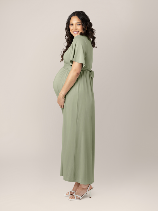 Model wearing the Wrap Maternity Maxi Dress in Rosemary with her hand on her baby bump @model_info:BreAuna is wearing a Medium.