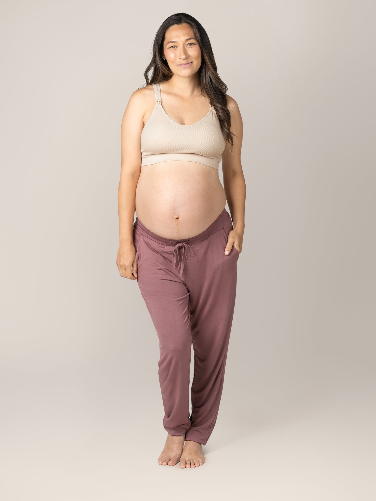 Full body front view of pregnant model wearing the Mia Maternity & Nursing Lounge Bra in Stone, paired with the Everyday Lounge Joggers in Twilight..