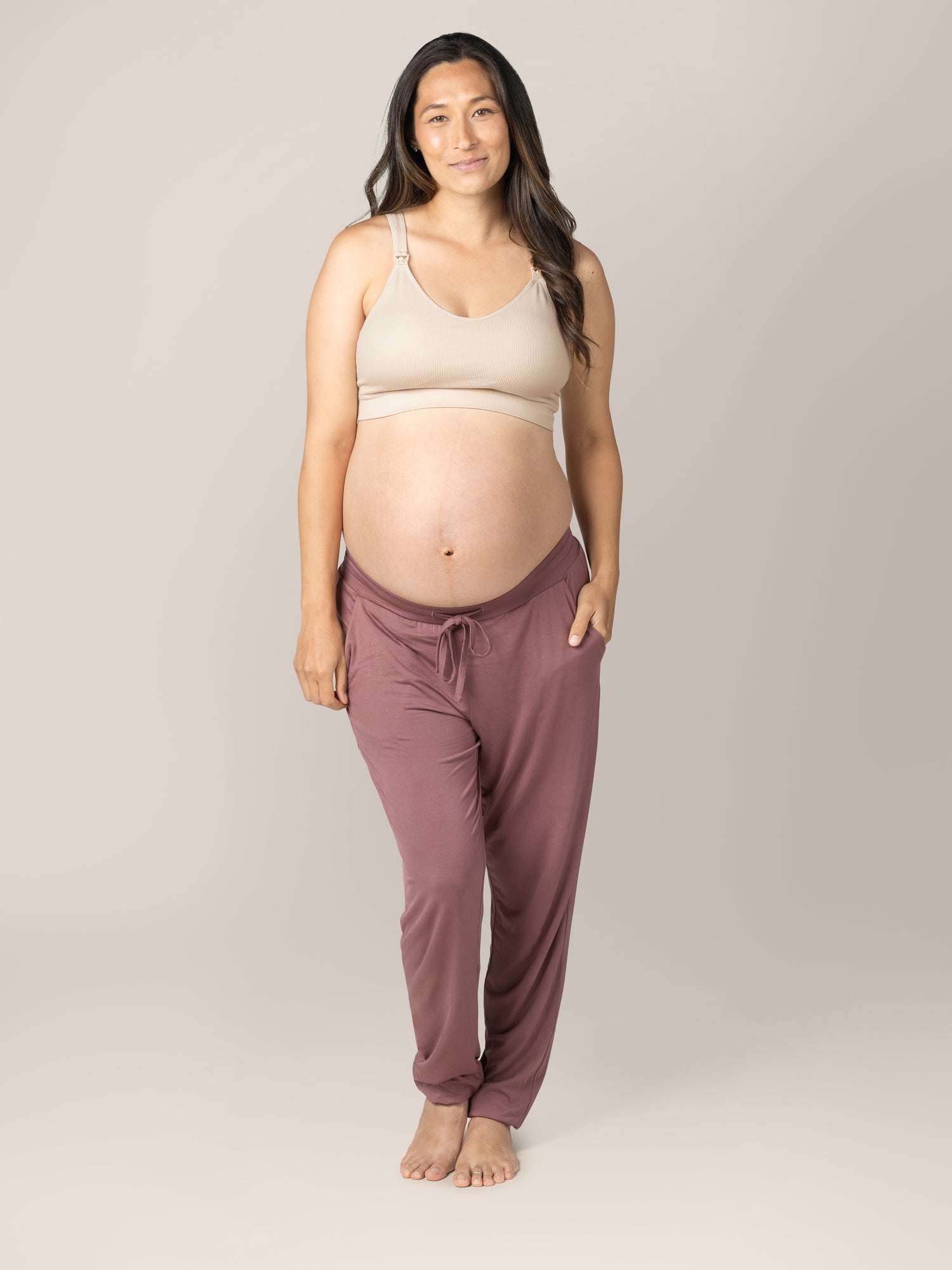 Full body front view of pregnant model wearing the Mia Maternity & Nursing Lounge Bra in Stone, paired with the Everyday Lounge Joggers in Twilight..