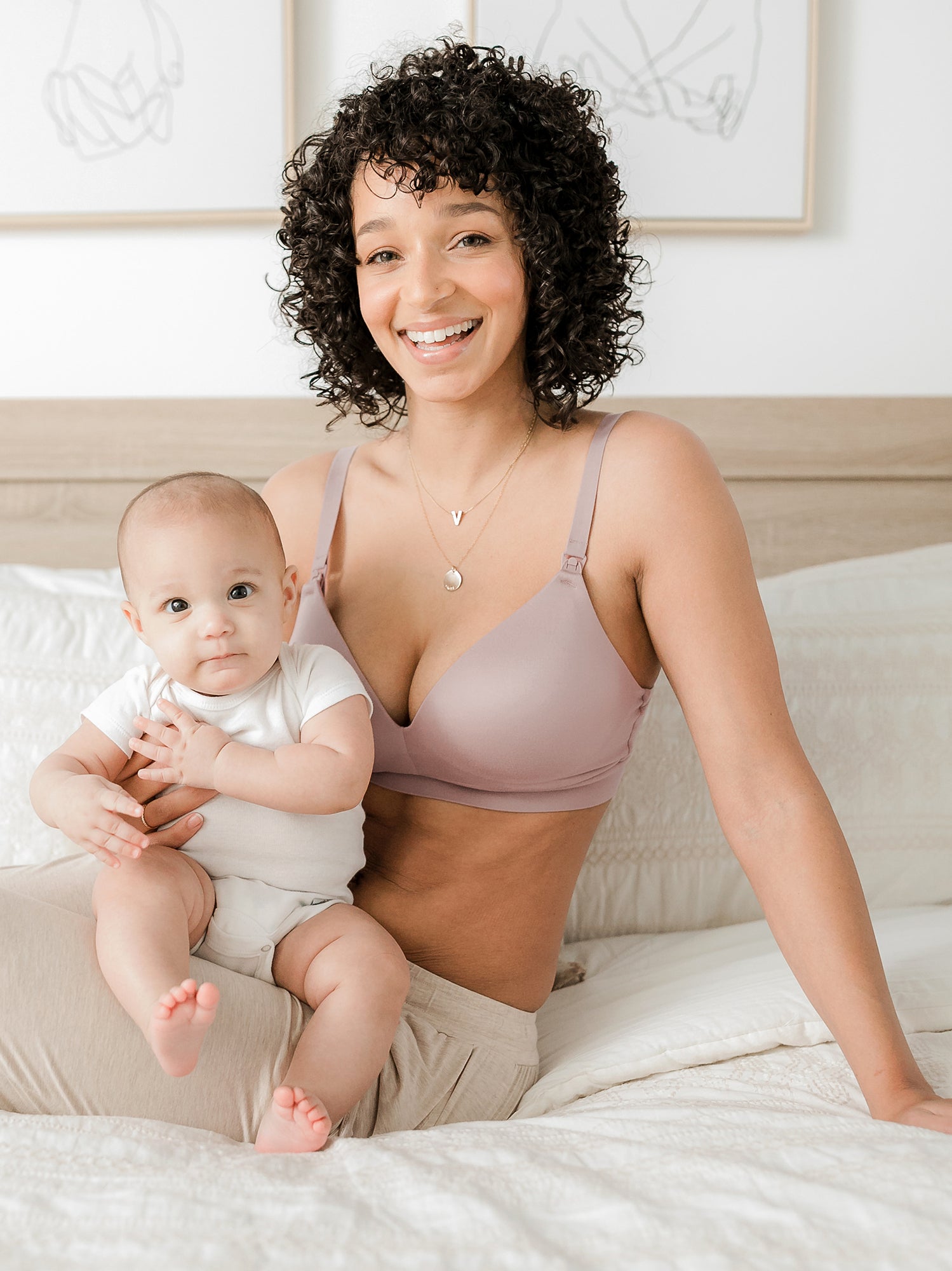 Model with baby wearing the Minimalist Hands-Free Pumping & Nursing Bra in lilac stone