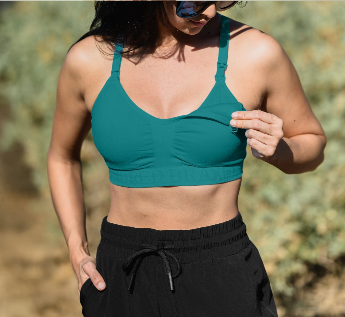 Model wearing the Sublime® Hands-Free Pumping & Nursing Sports Bra in Teal showing clip-down feature